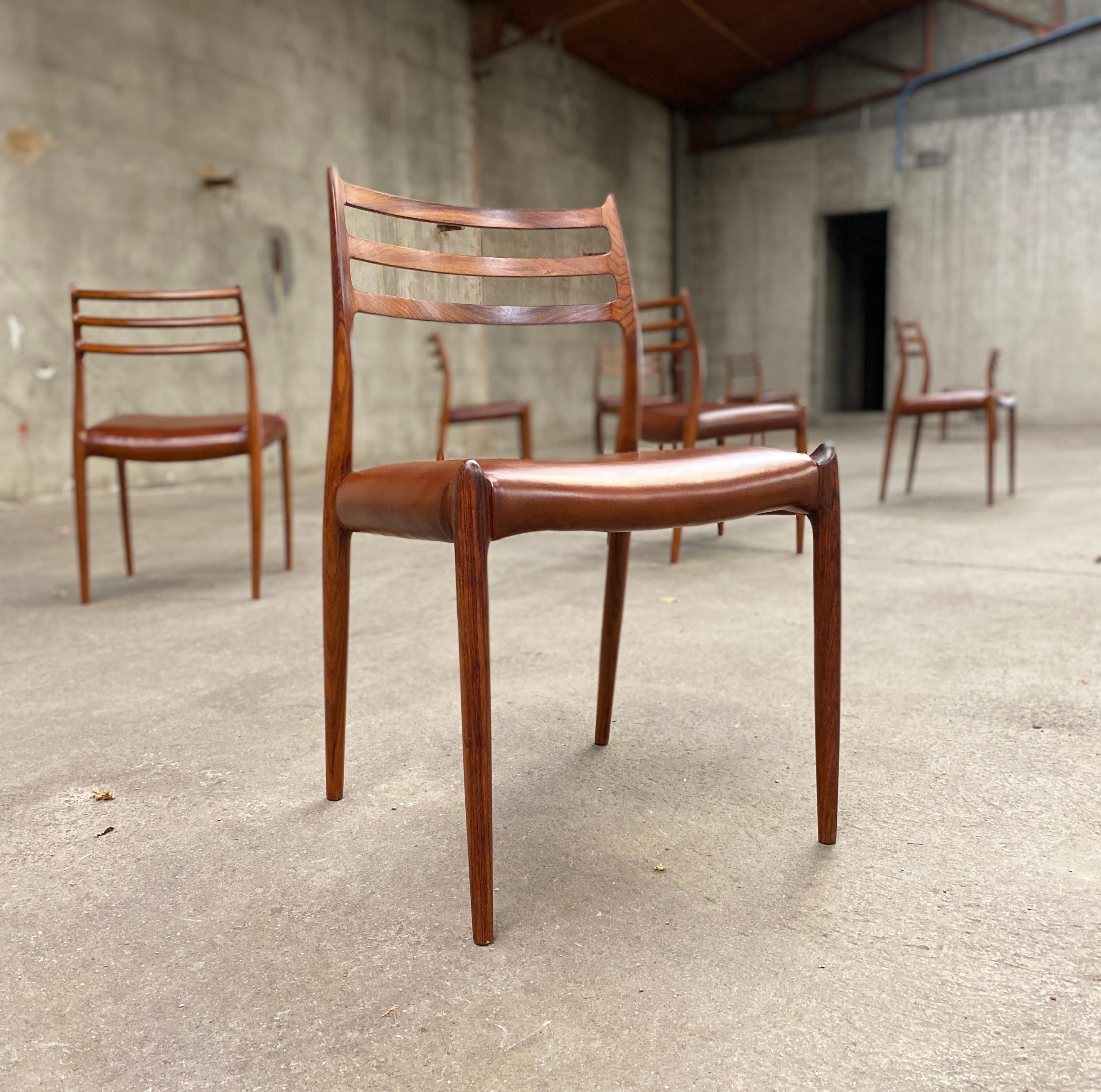 Set of eight rosewood dining chairs designed by Niels O. Moller for J.L. Moller Mobelfabrik, Denmark, 1962. 
Rare early productions with more slender frames. 
Seats reupholstered with new brown leather.
     