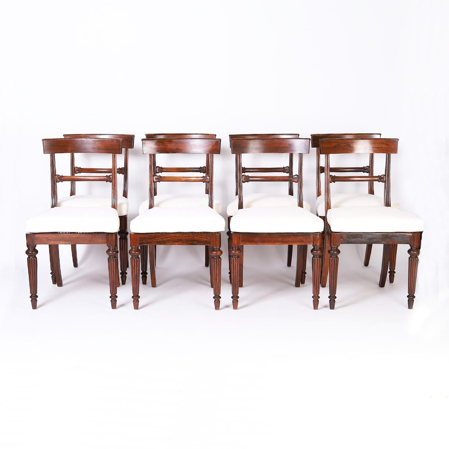 Set of eight 19th century William IV dining chairs crafted in rosewood with lush woodgrains and featuring Klismos style backs hand caned seats and elegant turned and beaded front legs.

Seat height with cushion is 18.5