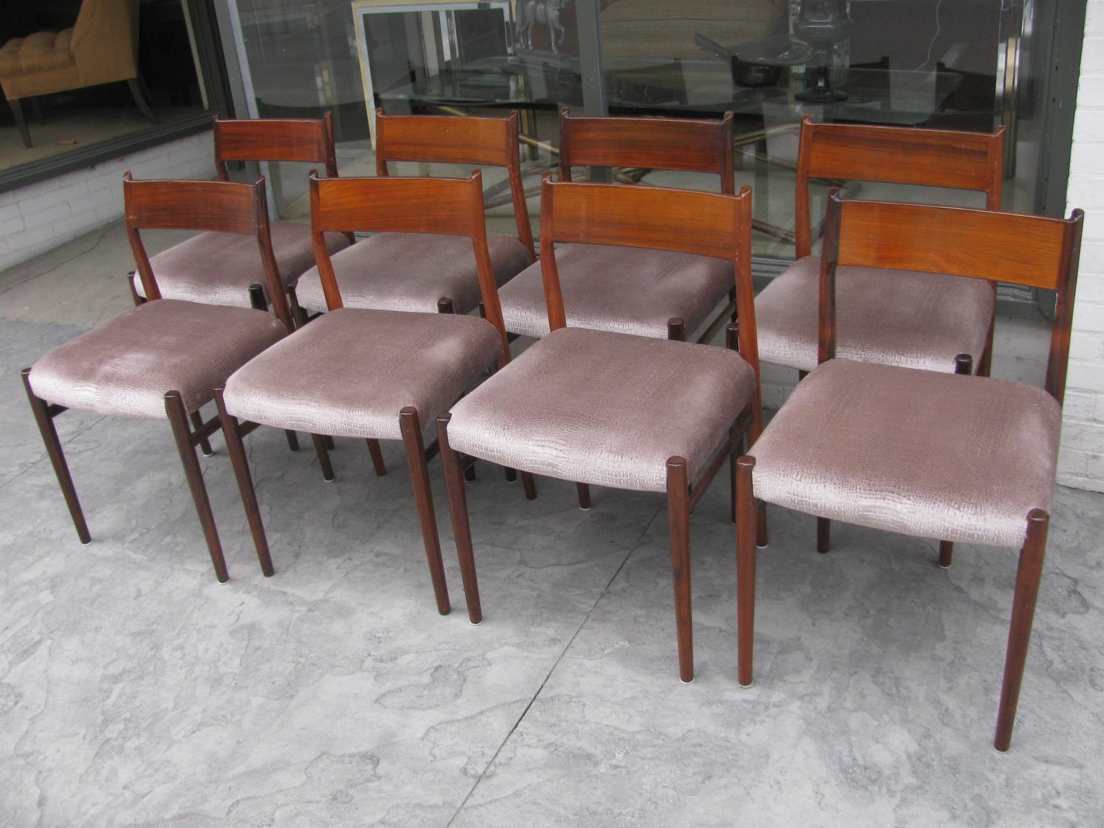 Fabulous set of eight solid rosewood dining chairs model #418 by Arne Vodder. Upholstered in a faux suede animal skin. Chairs are in excellent vintage condition, very tight and sturdy, normal scuffs to the finish.
