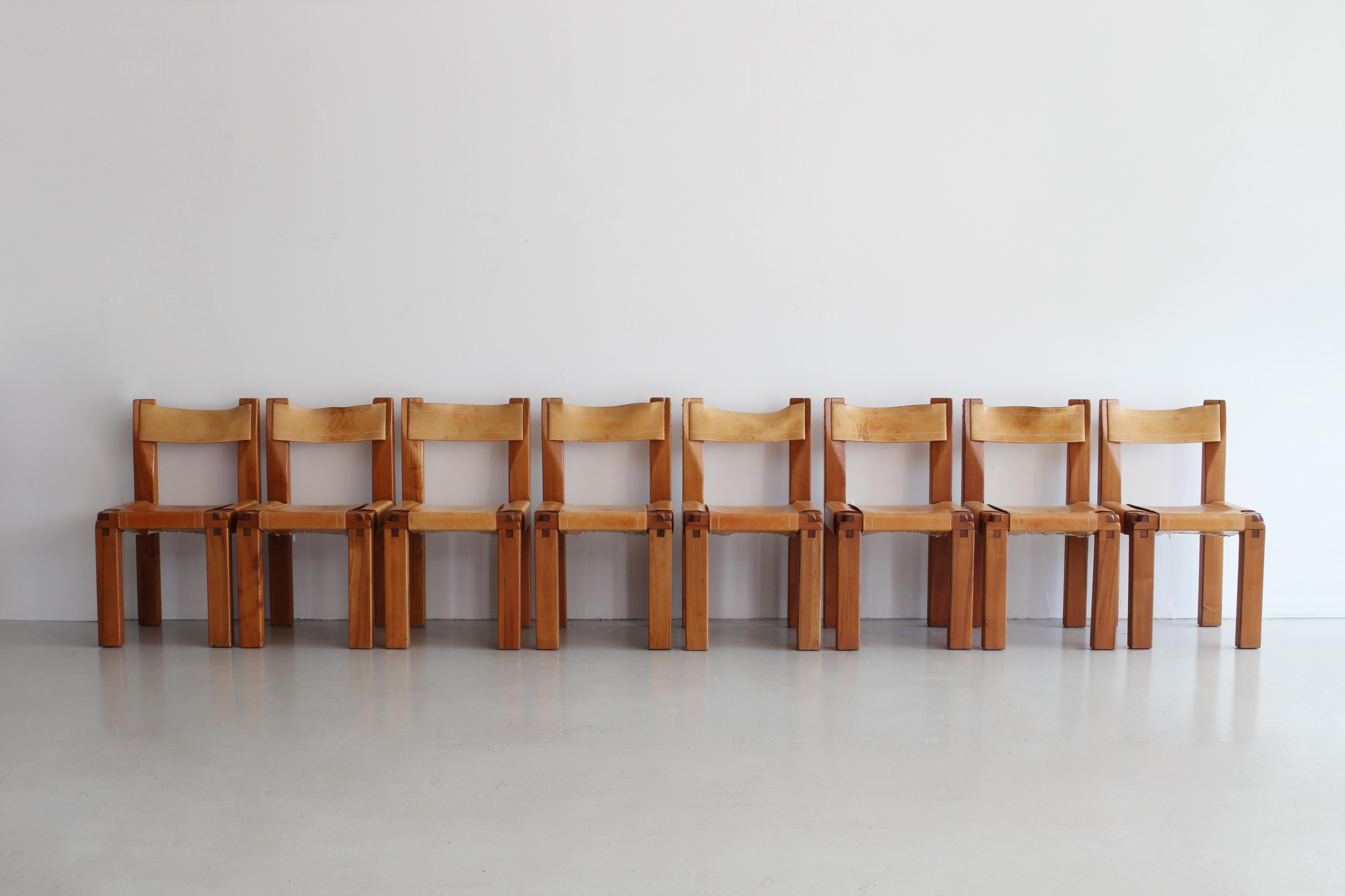 Set of eight dining chairs designed by French designer Pierre Chapo for Atelier Chapo, Paris. Cubic design of solid elmwood with saddle leather seat. Beautiful wood joint detail and fantastic patina to leather with contrast stitching. Priced as a