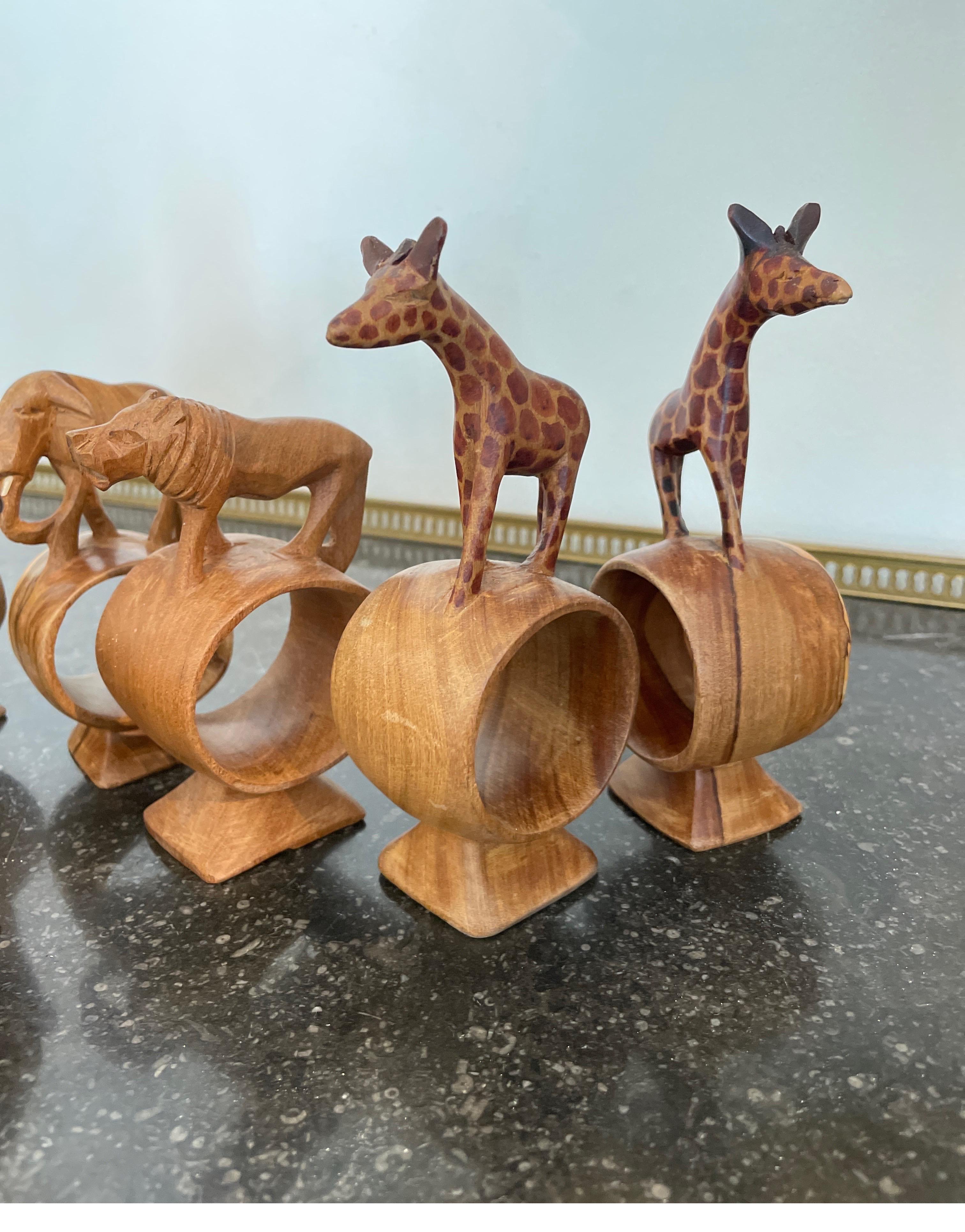 Set of eight hand carved safari themed napkin rings including an elephant, lion, zebra, leopard, two giraffes & two gazelles.