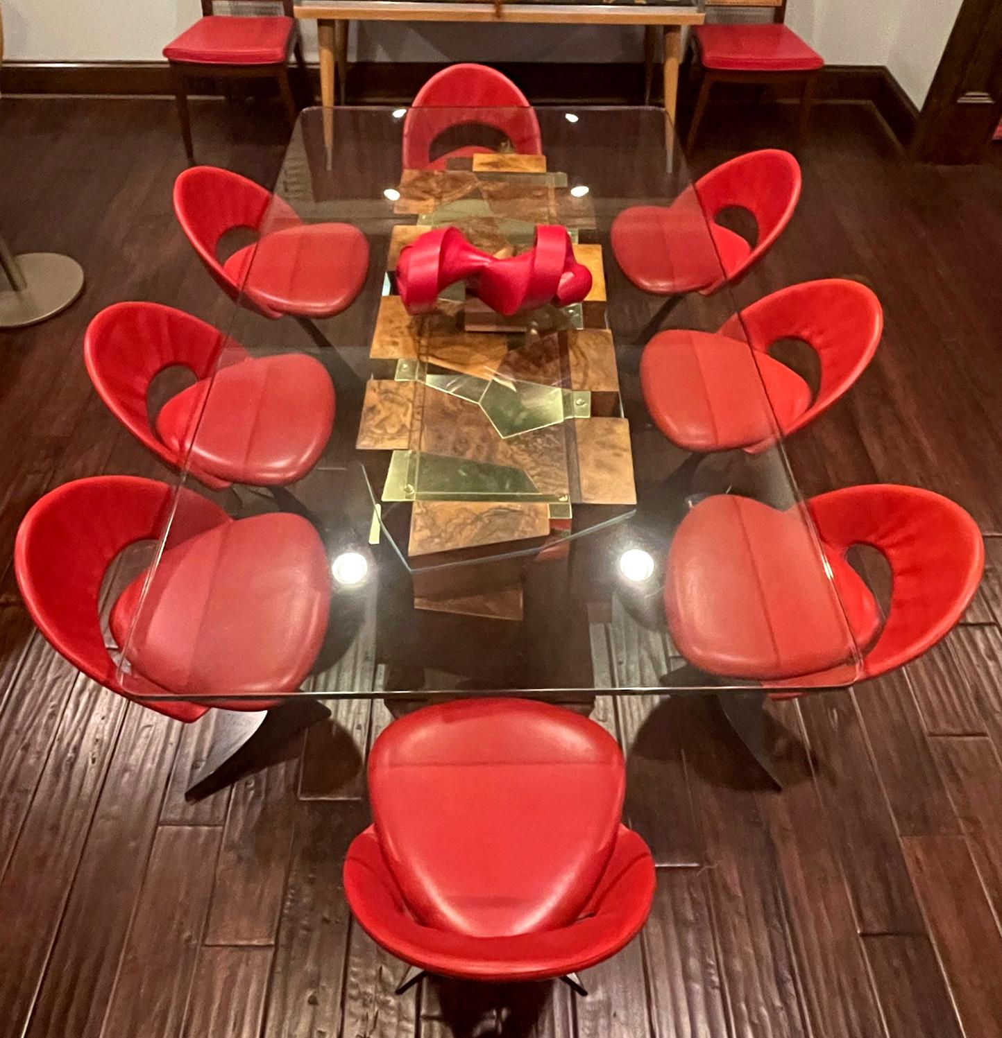 A set of sculptural pedestal chairs in black enamel steel frame and red leather upholstery designed by Spanish architect Santiago Calatrava (1951-). These limited production chairs were manufactured by De Sede for the famed Tabourettli Theatre in