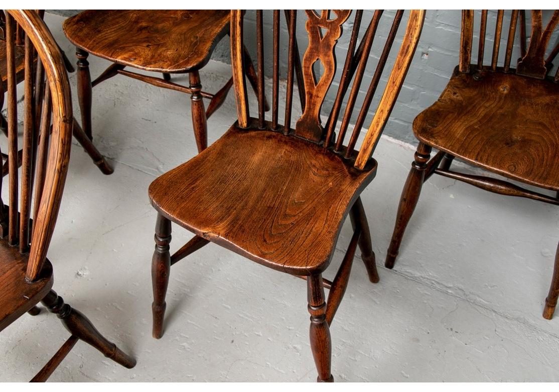 20th Century Set of Eight Semi-Antique Wheel Back Windsor Chairs