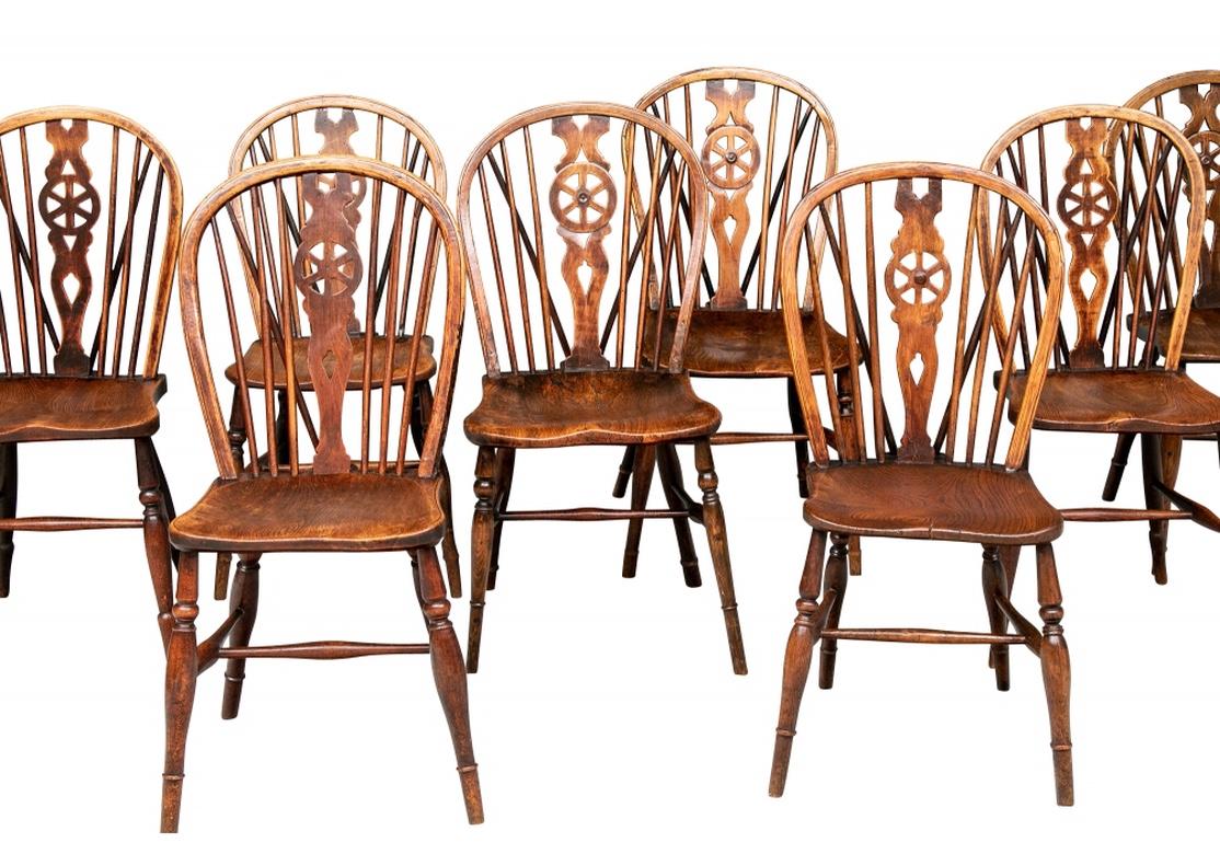 A fine timeworn mixed group of chestnut tone Windsor chairs in original condition dating from the late 19th-early 20th century. The group is four and four, one group being two inches higher than the other four, however all having the same styling