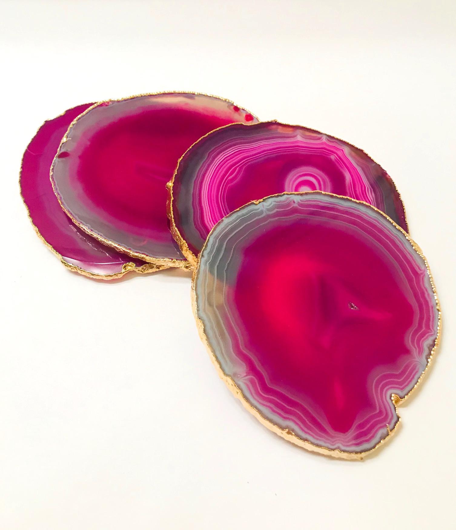 Stunning natural agate and crystal coasters with 24-karat gold-plated edges. Polished fronts and natural rough edges. No two pieces are alike. In gradient hot pink with taupe and grey accents. Make beautiful accessories to any coffee table or dining