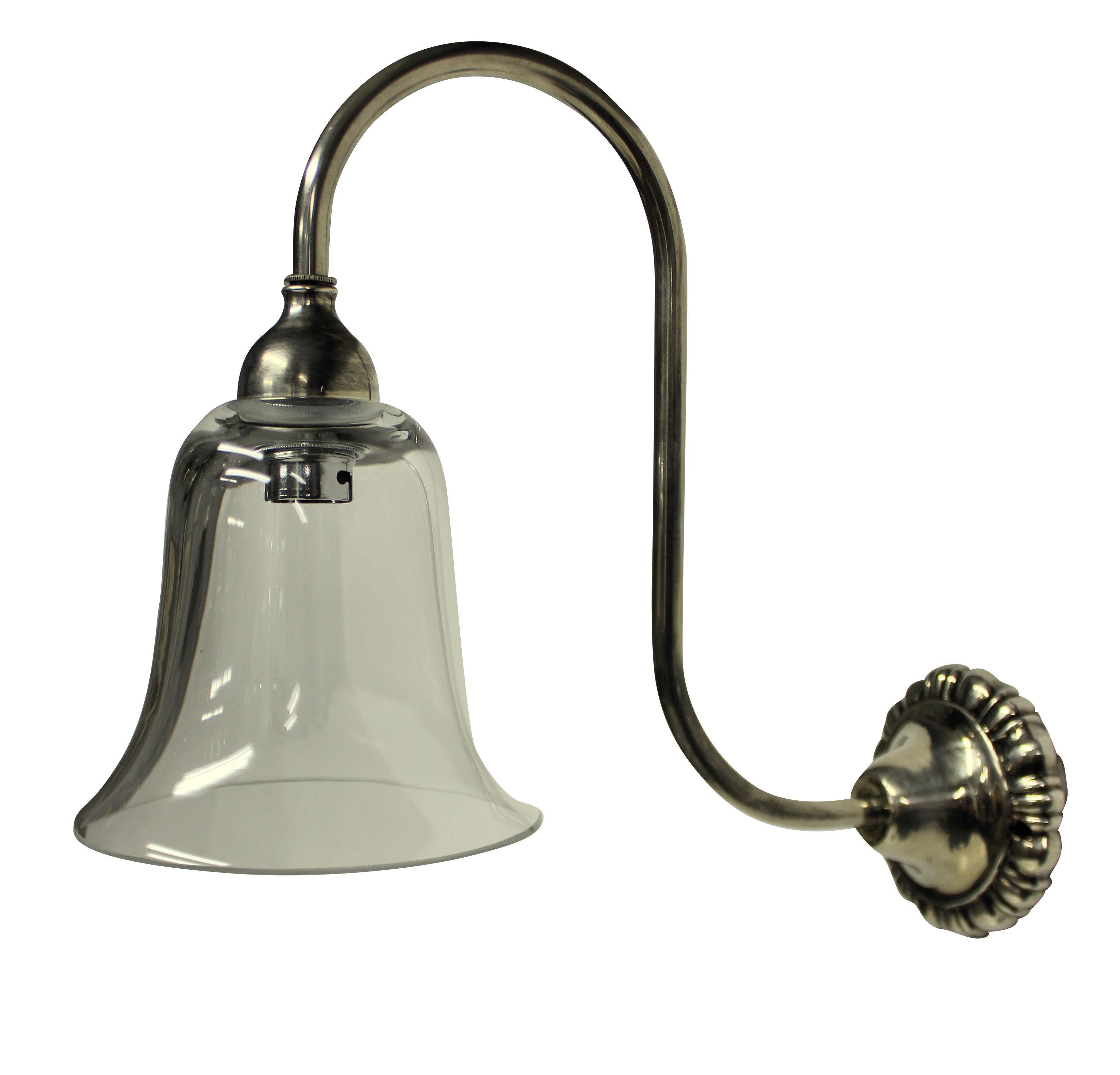 A set of eight English swan neck wall lights in silver plated brass, each with a bell shaped glass shade.