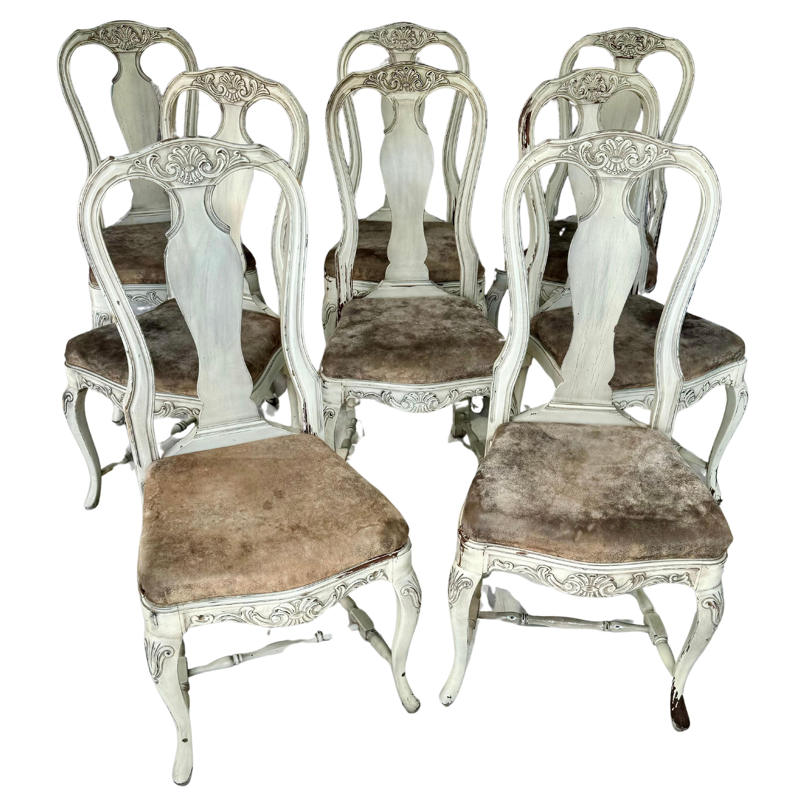 Fine set of eight mid 20th century Swedish Rococo style dining chairs. Lovely chairs feature ornate carved details, shapely curved backs and cabriolet legs, with seats upholstered in brown leather fabric. Each chair is supported by an H stretcher.