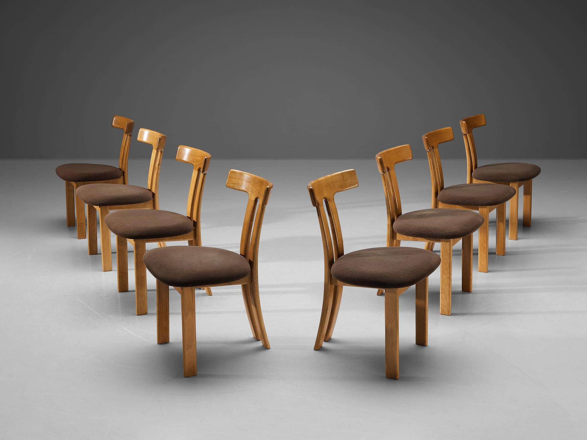 Set of eight dining chairs, beech, fabric, Europe, 1960s. 

These dining chairs have a strong resemblance to Carl Hansen's T-chair and the dining chairs by Sapporo for Mobil Girgi, yet this design is different in its details. Sharp vertical and