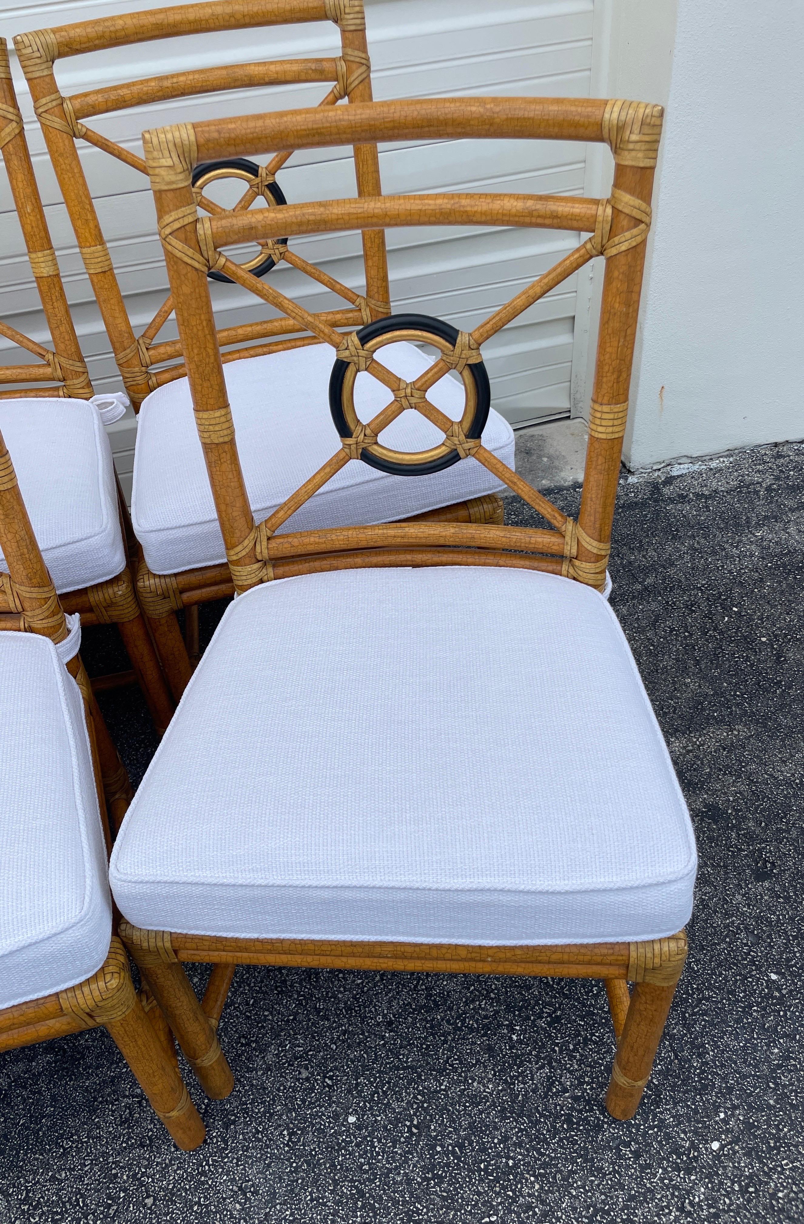Set of eight Mc Guire Target back chairs with newly upholstered white cushions.  They are ready to be paired with the table of your choice. A wonderful classic set. 