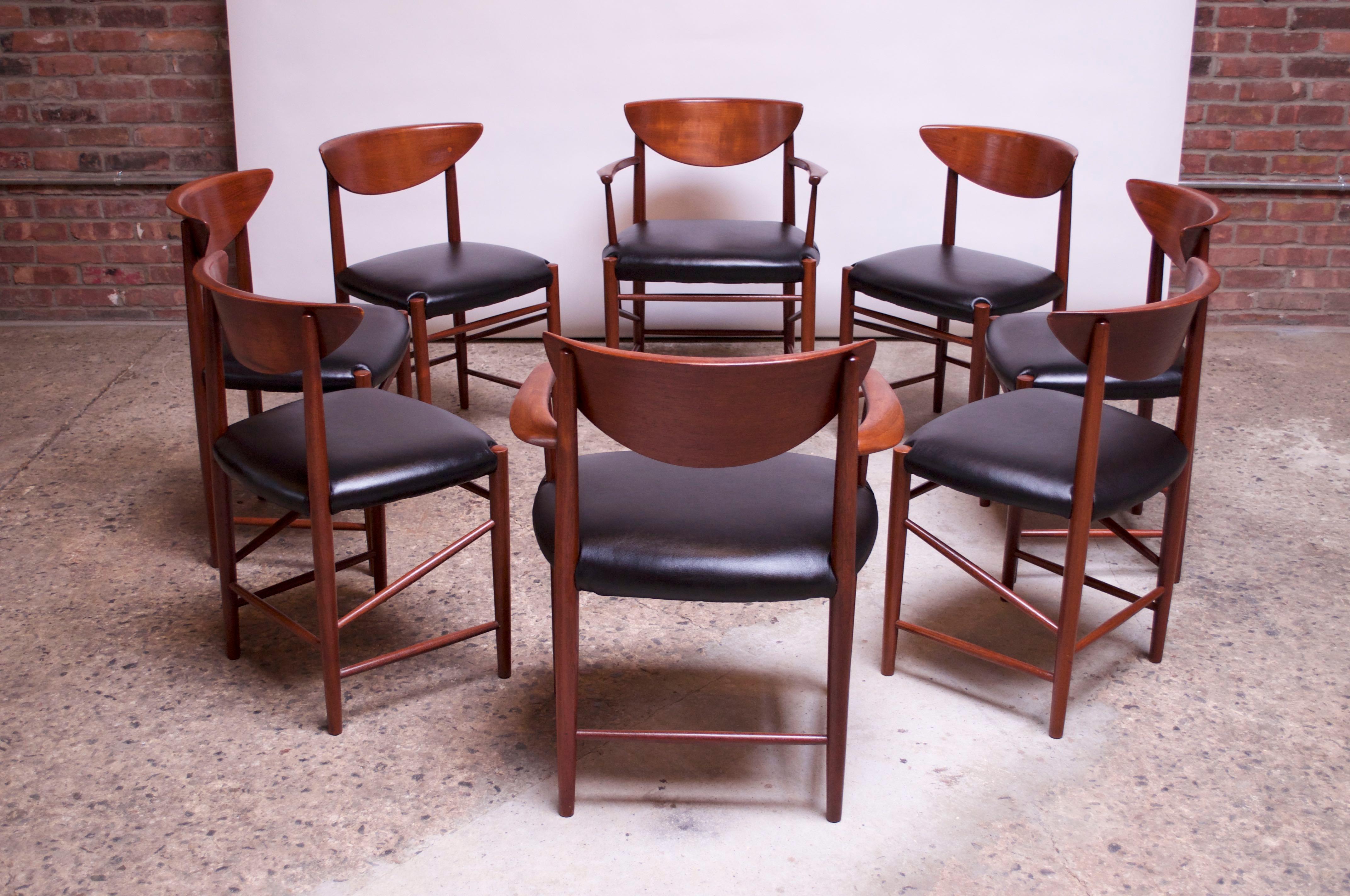 Set of eight dining chairs (Model #316) by Peter Hvidt and Orla Mølgaard Nielsen for Soborg, Denmark, circa 1955-1956. Set includes two armchairs (captains) and six side chairs. 
Composed of solid teak frames with sculpted backs and newly