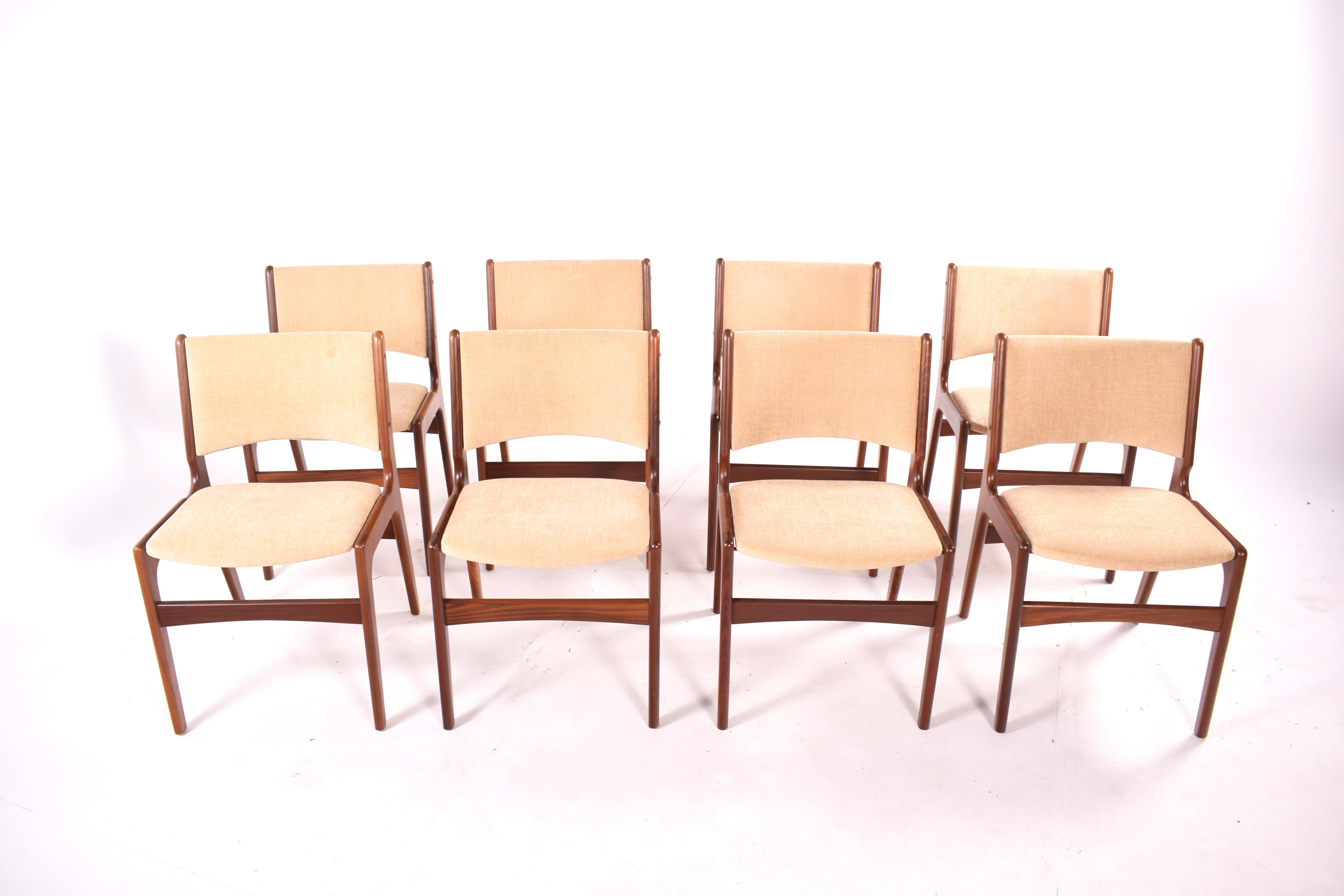 A set of eight gorgeous 1960s, dining chairs, high back. Solid teak wood frame. New upholstery in beige fabric. Manufactured in Denmark.