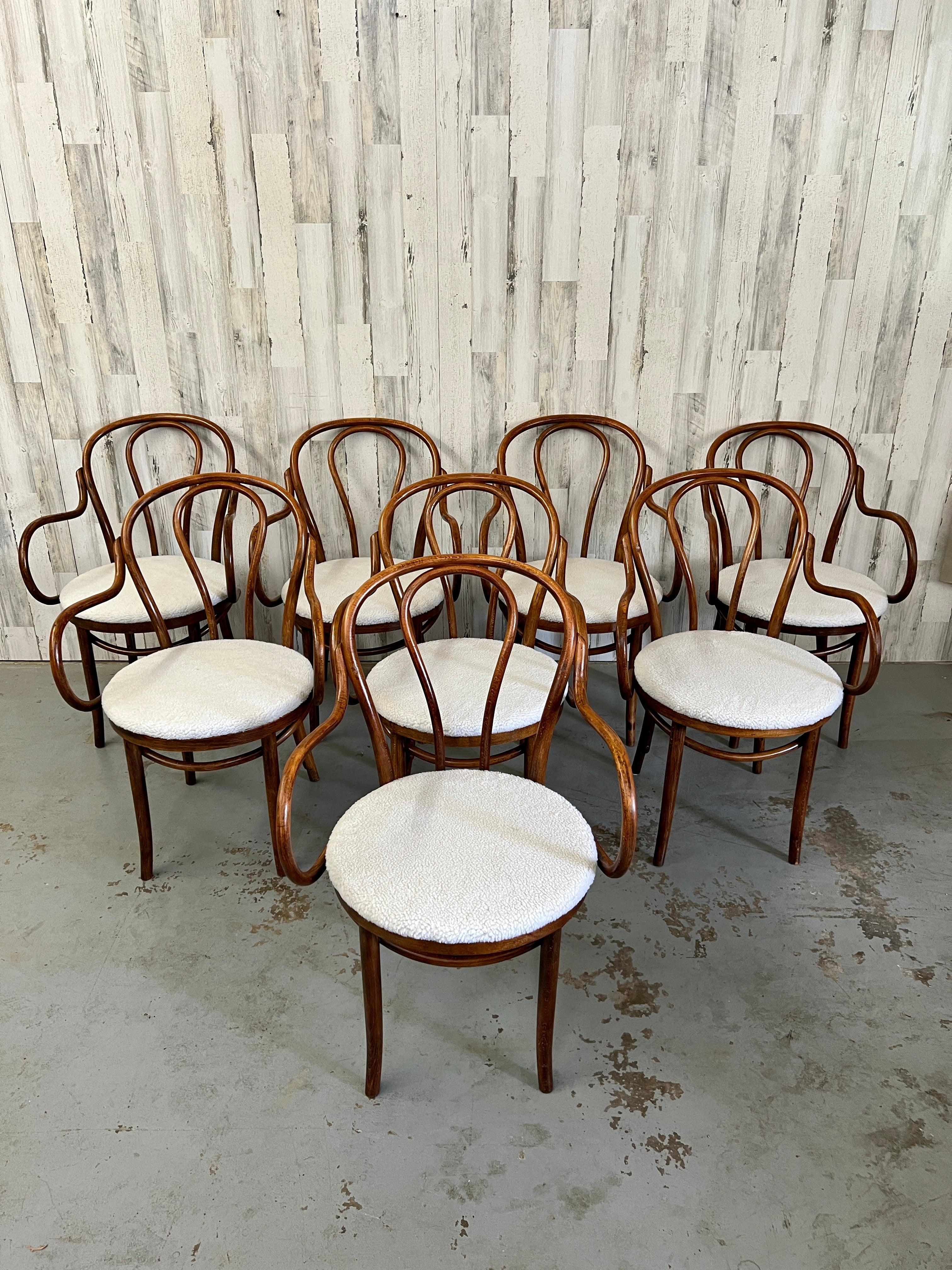 Very hard to find a set of eight bentwood arm chairs by Thonet.
New Sherpa teddy bear fabric on the seats.