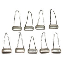 Juego de ocho Tiffany & Co. Etiquetas de Decantador de Plata de Ley Americano, circa 1930