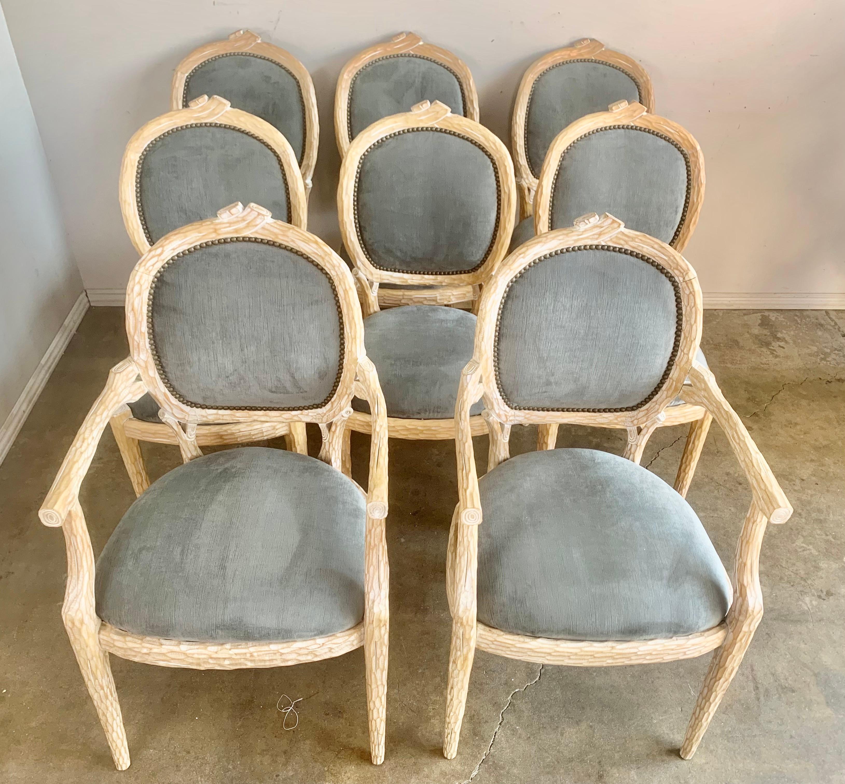 Set of (8) dining chairs carved to look like branches from a tree. The beautiful natural wood finish add to the natural look of the chairs. The dining chairs are newly upholstered in blue velvet with brass nailheads.

Size of armchairs: 38