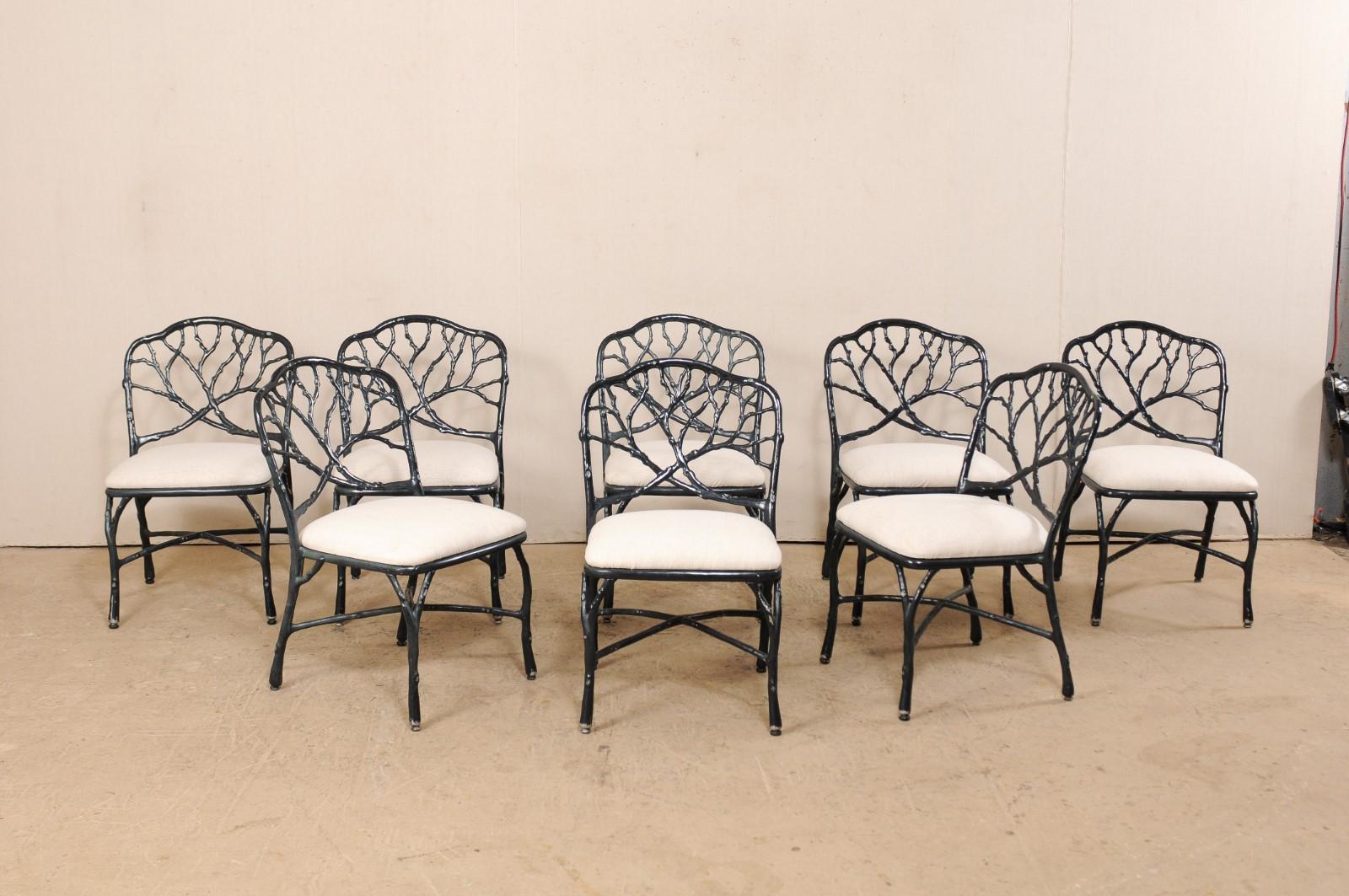 A set of eight vintage American indoor / outdoor dining chairs with branching tree limb motif. These side chairs have been masterfully created from cast aluminum, with a powder coated finish. The chair backs have a playful crossing branch and twig