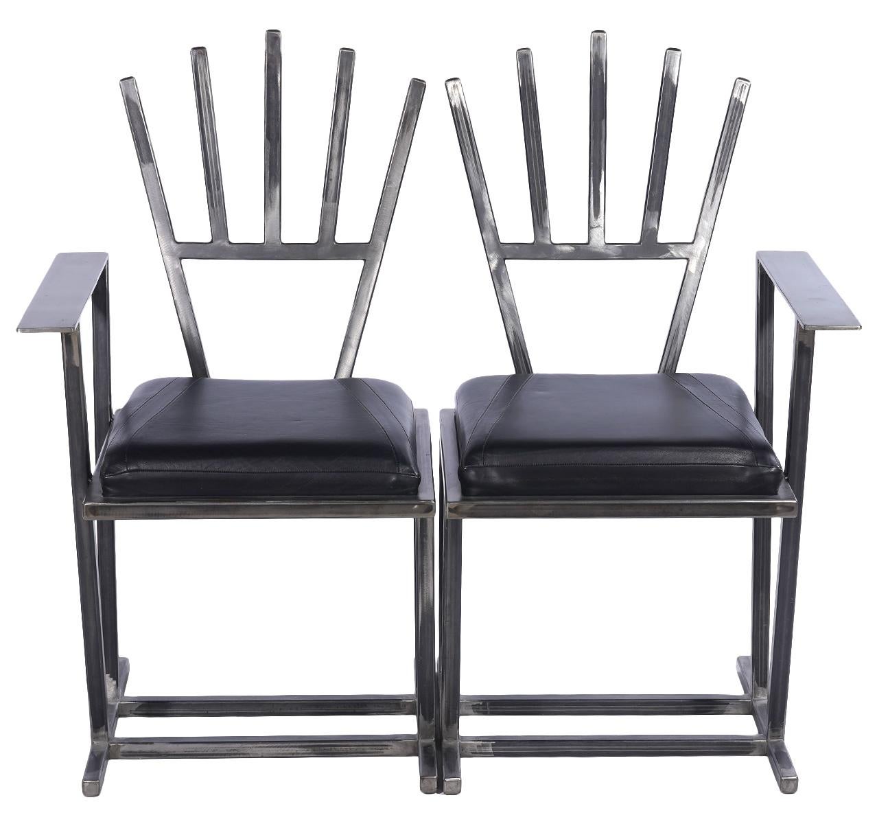 Gary Kulak, American (Born 1952). Set of 8 single arm chairs that fit into sets of two. Handmade steel chairs with leather seats. Measures: 38.5