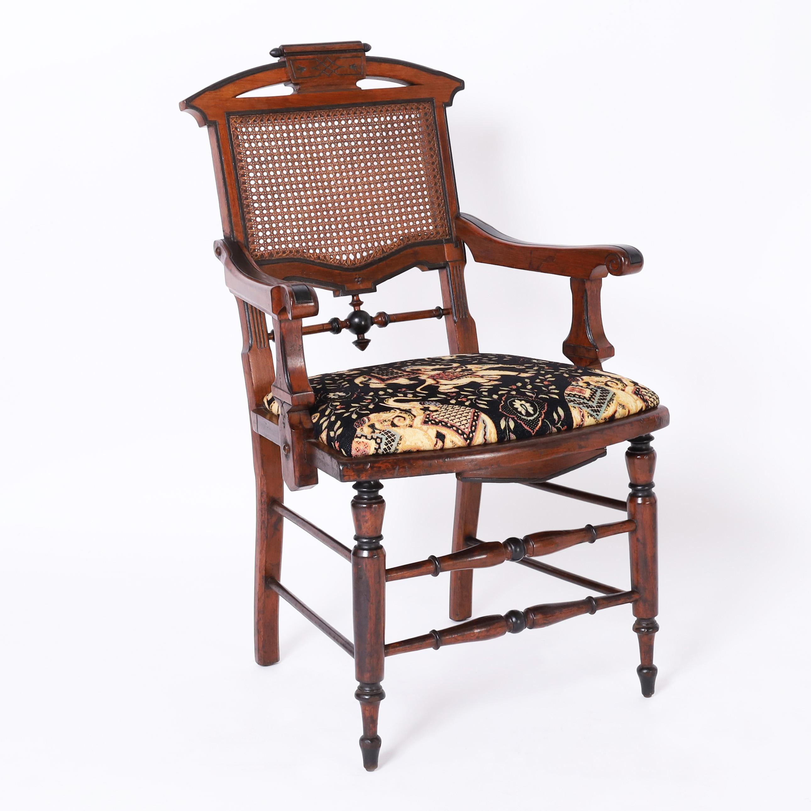 Rare and remarkable set of eight 19th century English dining chairs having two armchairs and six sides crafted in mahogany with ebonized highlights featuring eastlake style crests, caned backs, aesthetic movement stick and ball and turned legs and