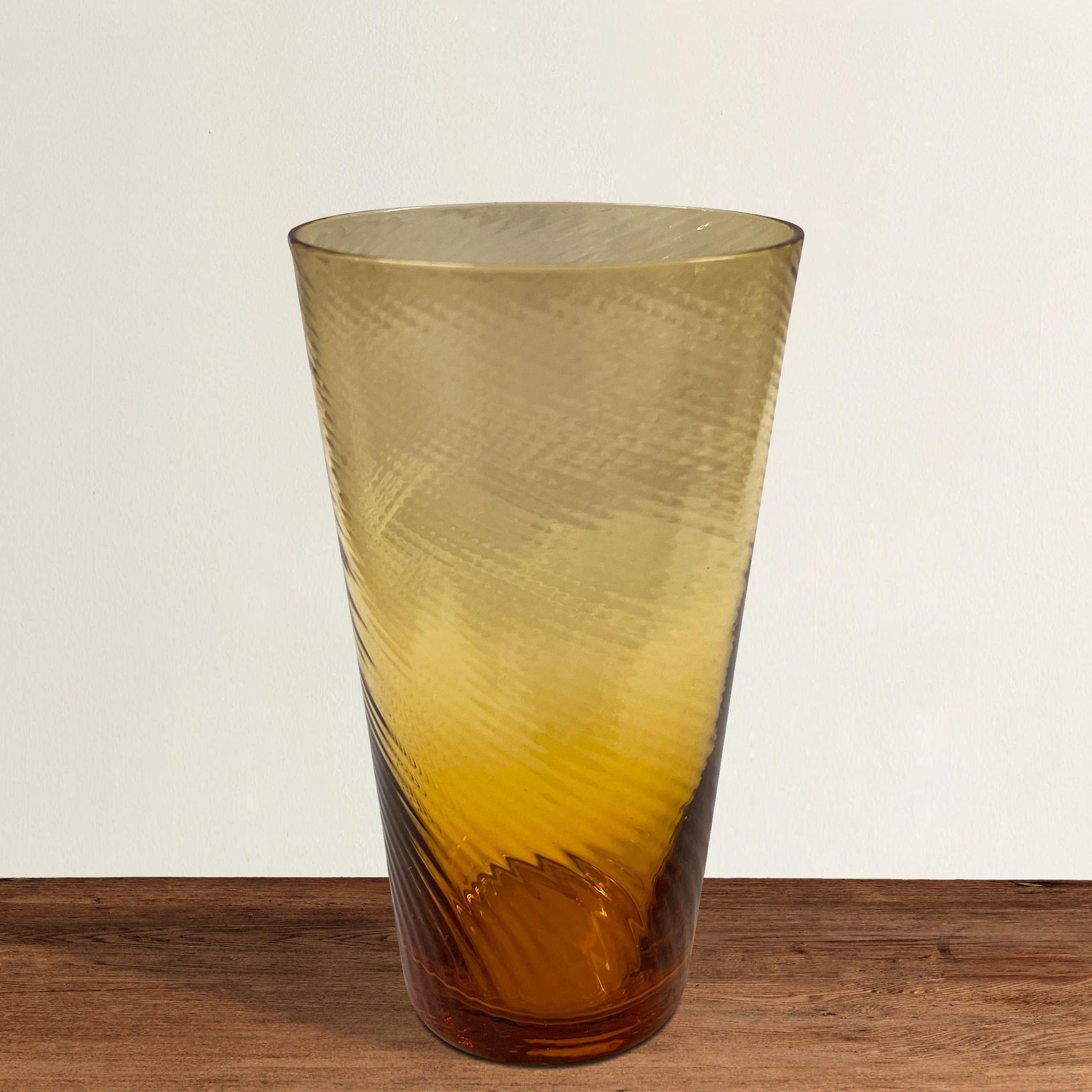 A wonderful set of eight vintage American hand blown amber glass tumblers with a swirled pattern, just waiting for your next garden or beach party!