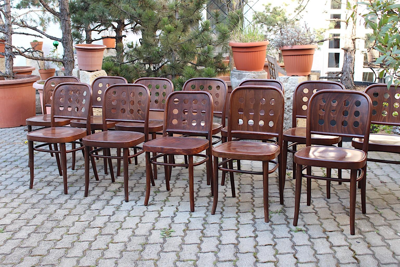 Josef Hoffmann style 8 vintage dining chairs from beech bentwood in chocolate brown color tone 1990s in an amazing shape.
While the backrest features 12 holes for an interesting form, the seat invites with for a comfortable seating.
The dining