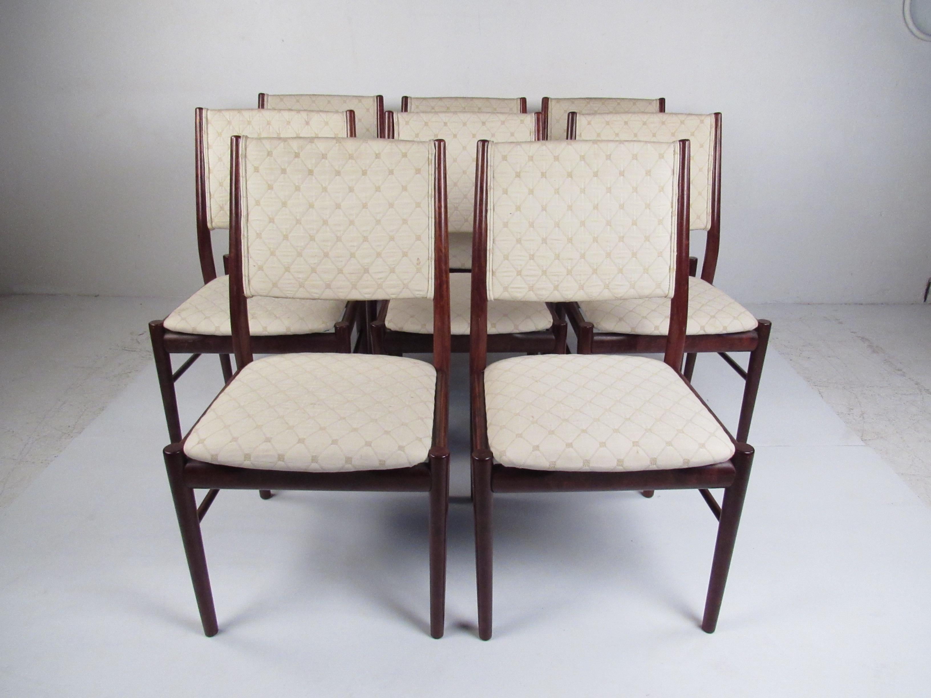 Set of (8) chairs crafted by one of Denmark’s respected mid-century furniture makers, these chairs embody the refined simplicity and superb craftsmanship that define Scandinavian design. The luxurious rosewood frames display stunning natural grain
