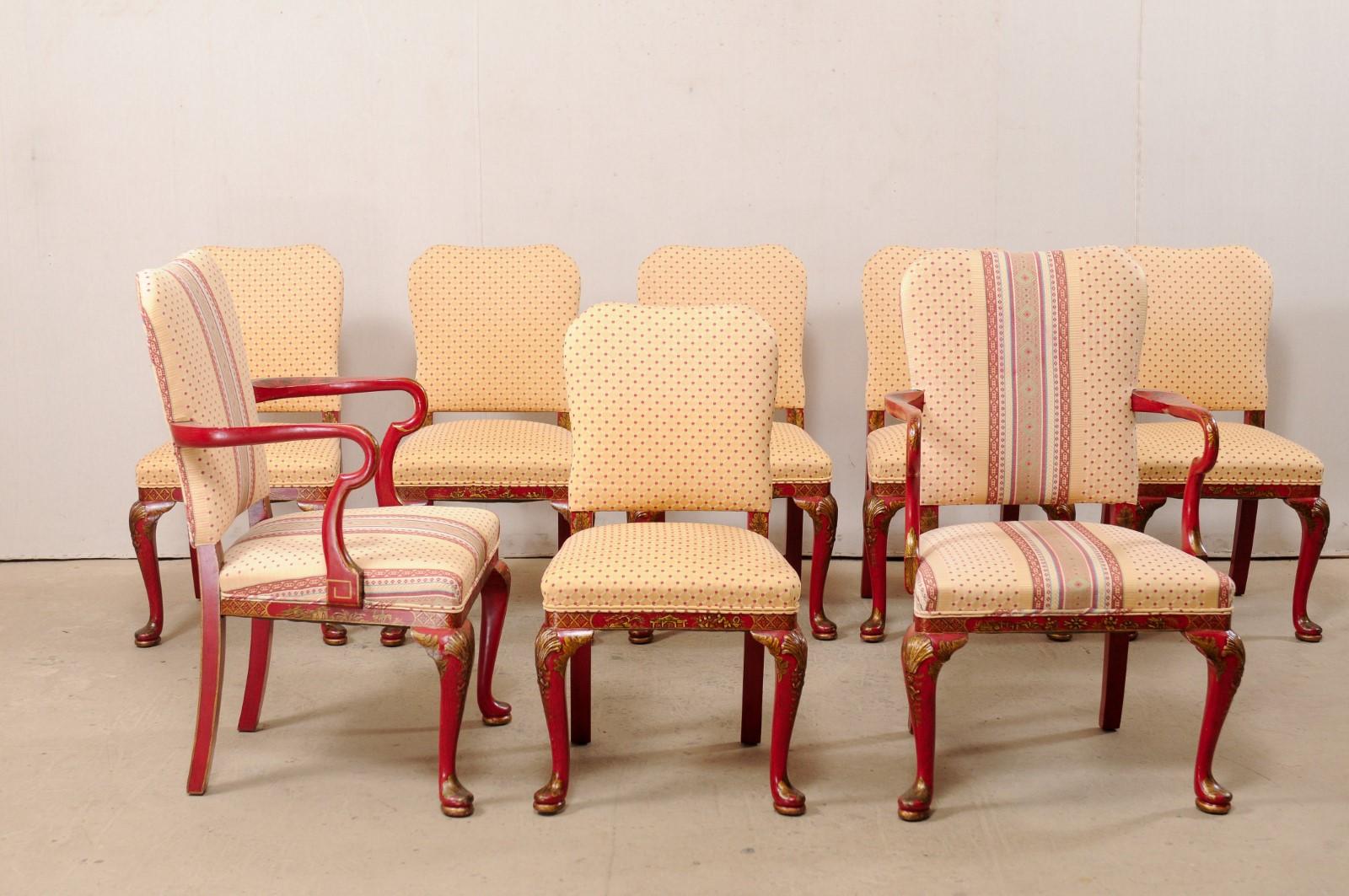 A vintage American set of eight dining chairs with hand painted chinoiserie. This set of chairs, which consist of 2 armchairs and six side chairs, feature upholstered seats and backs, with red and gold tone painted wood frames, in a lovely