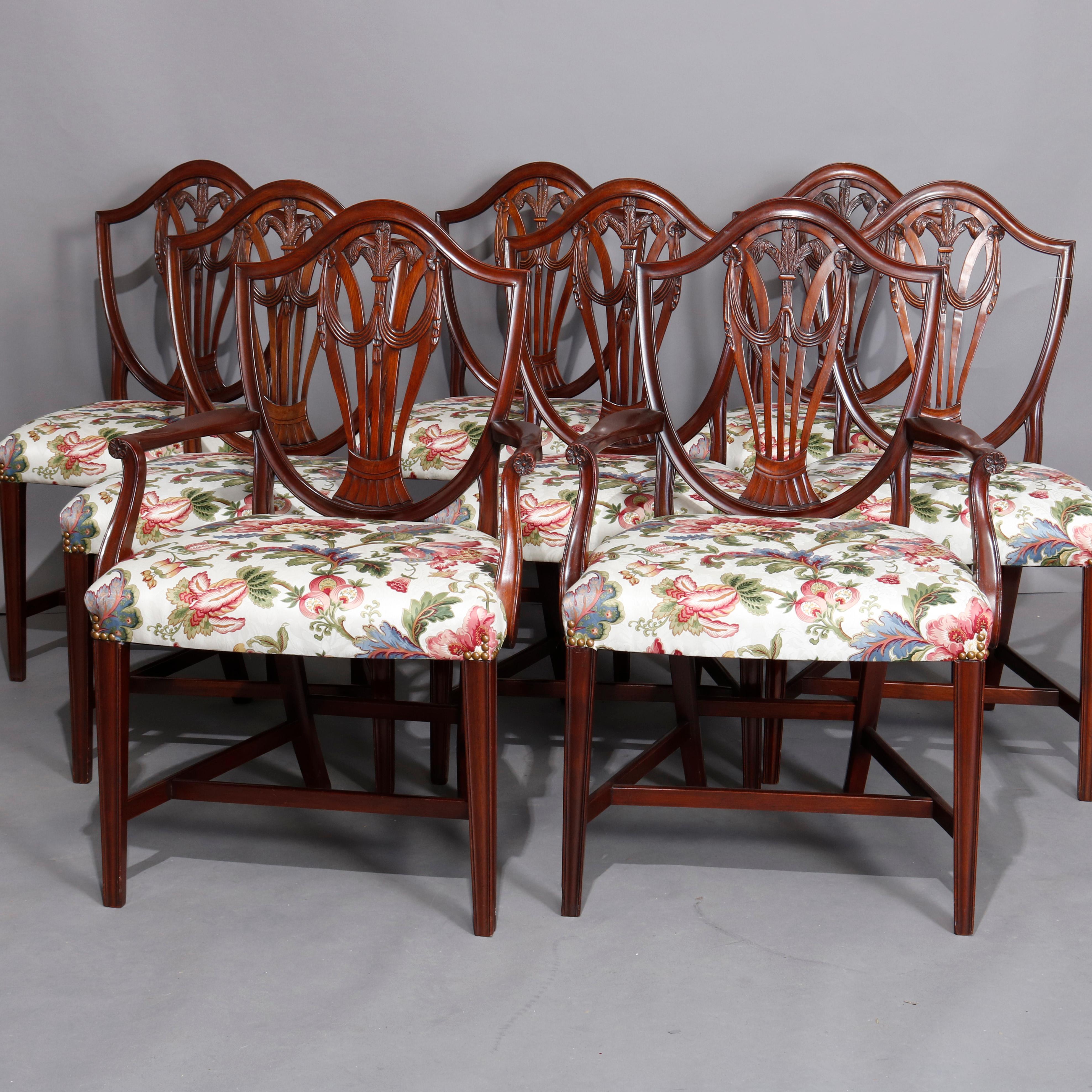 A vintage set of 8 English dining chairs offer mahogany frames with shield form backs with central carved fleur de lis palmette with flanking drape elements and upholstered seats, circa 1930

***DELIVERY NOTICE – Due to COVID-19 we are employing