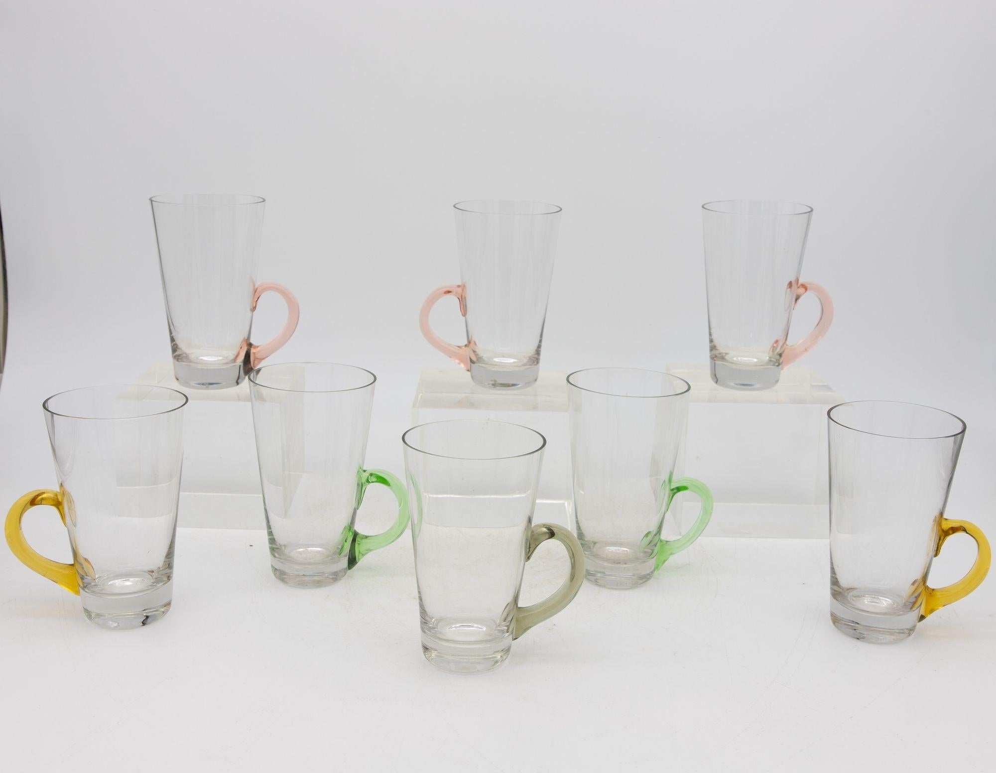 A delightfully whimsical set of eight vintage Hot Toddy glasses. Each glass has a pale pink, yellow, green, or gray handle. Enjoy a classic cocktail by the fire with friends and this set that is made for entertaining. Please note there are three