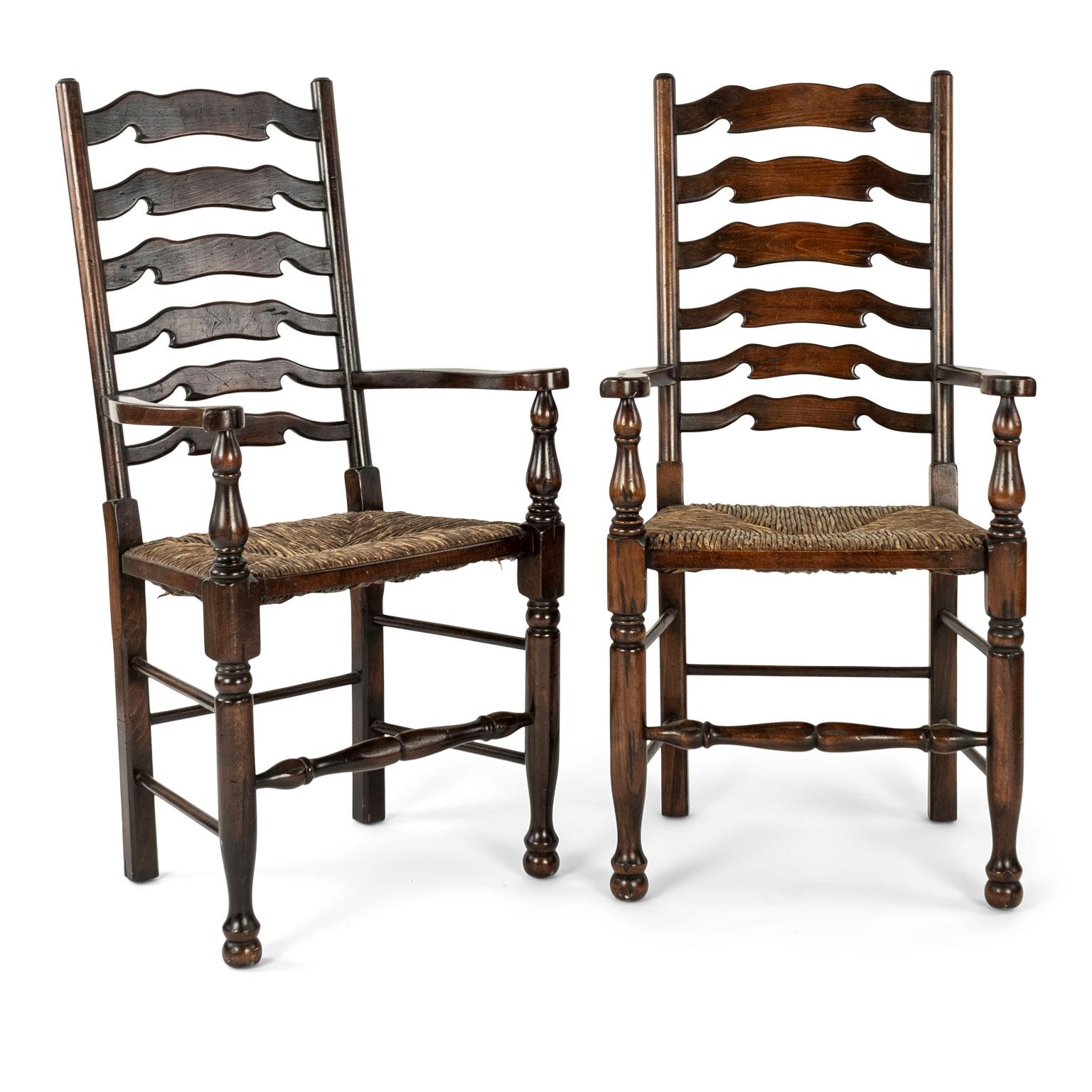 Set of eight vintage ladderback chairs: six side chairs and two complimentary armchairs. Turned and carved with rush seats and constructed with mortise and tenon and pegged joints. Sold together and priced $6,400.00 for the set.
 
