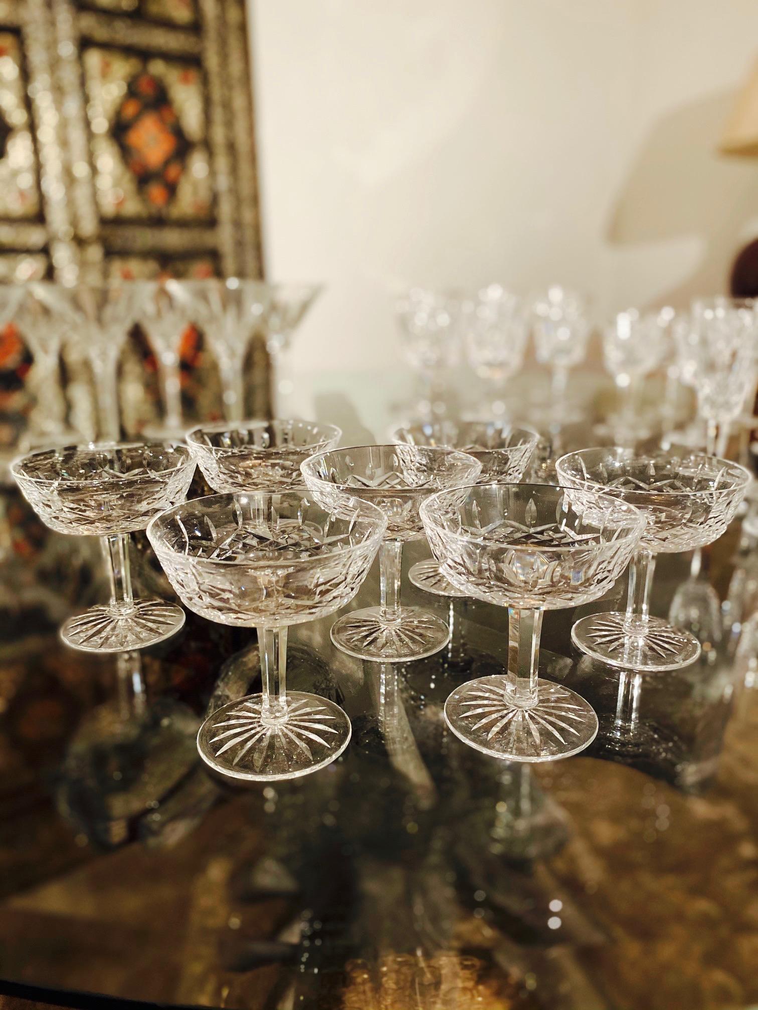 Set of eight luxury crystal coupe champagne glasses from Waterford Crystal. The Lismore Collection is perhaps Waterford's most distinguished design featuring handblown crystal with the pattern's signature diamond and wedge cuts. First introduced in