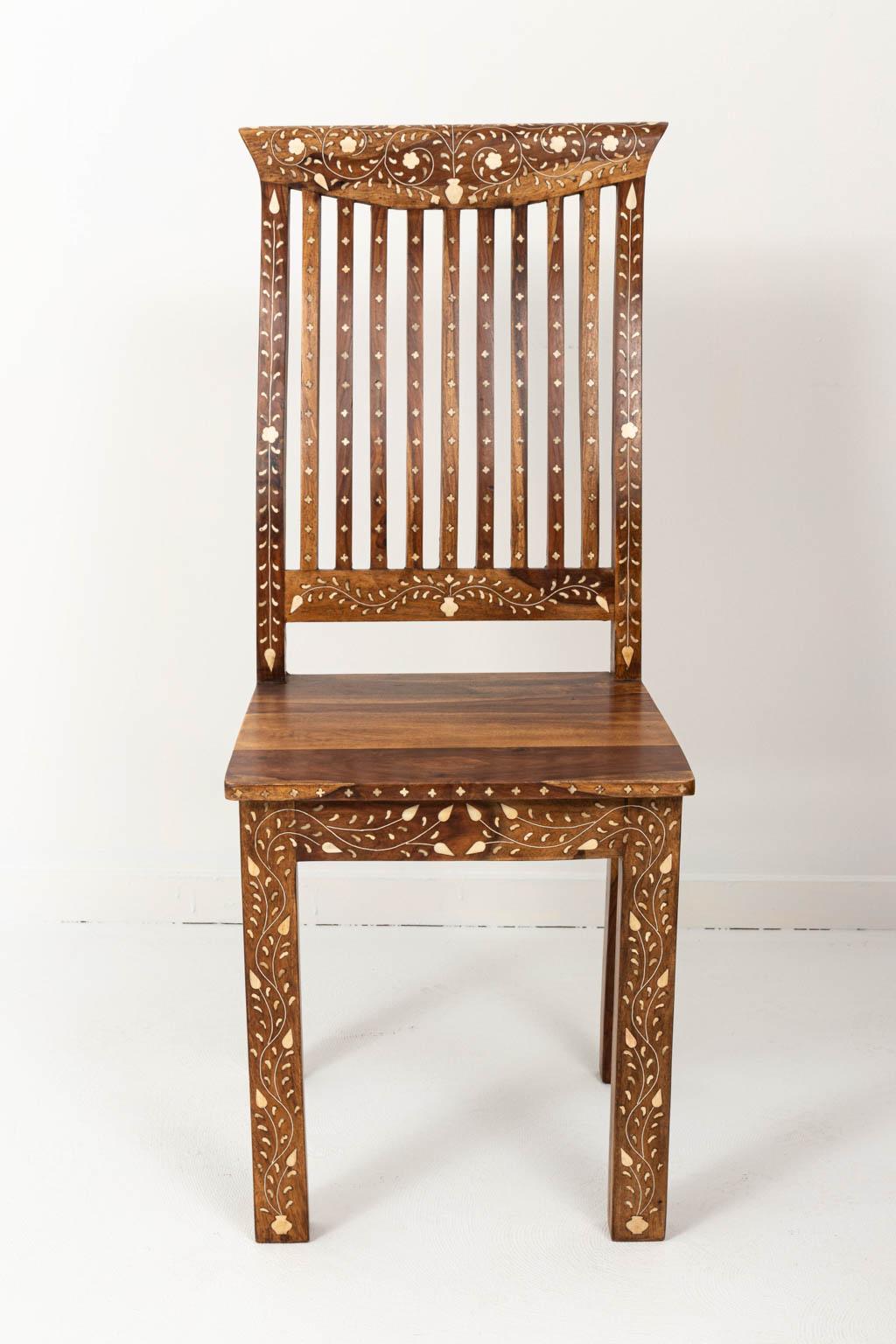 Set of eight walnut and bone in laid dining room chairs with floral detail. Please note of wear consistent with age.