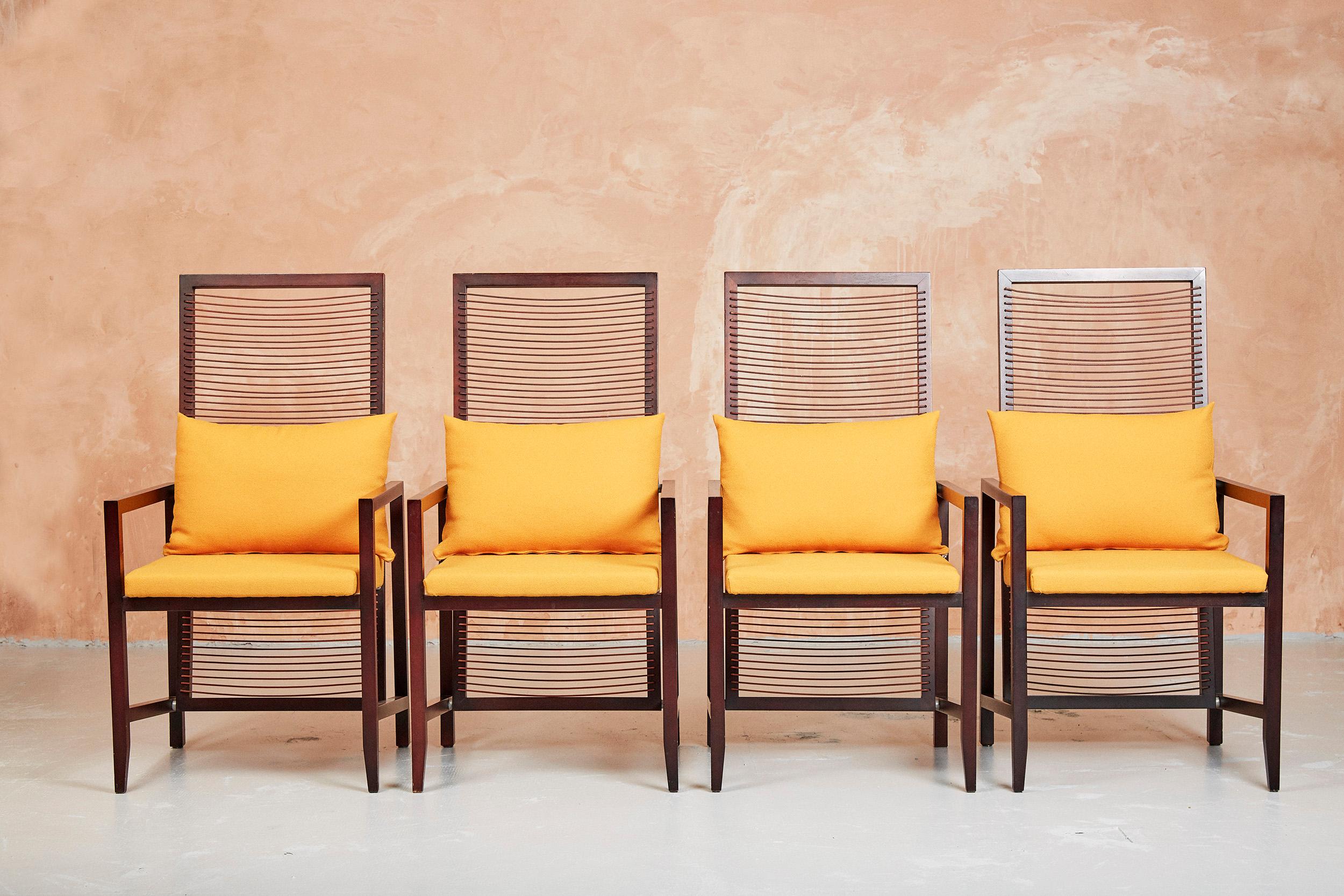 Set of 8 Astoria dining chairs by Franco Bizzozzero for Bonacina, Italy.

Solid Walnut “Noce Canaletto” frame with natural leather cord back and bold ochre yellow upholstery.

We have 8 chairs available in total.