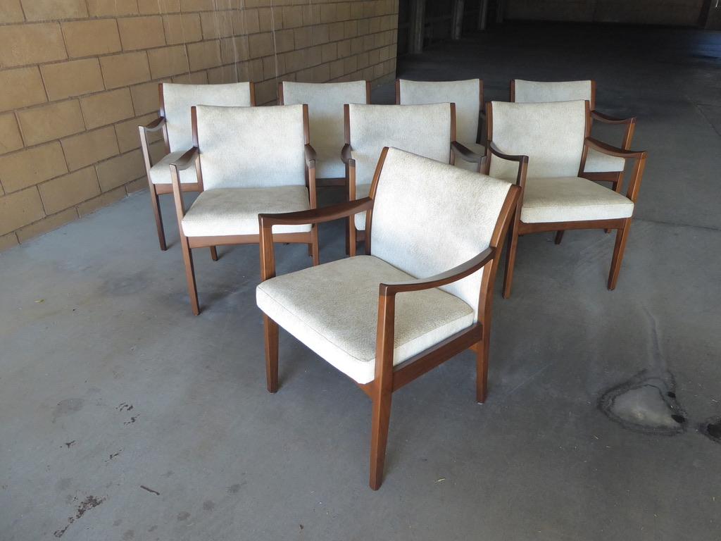 A gorgeous set of eight walnut dining chairs by Johnson Chair Co. These are all armchairs and are newly reupholstered in a beautiful nubby fabric that is most appropriate to the period and style. Commodious and comfortable these chairs are also