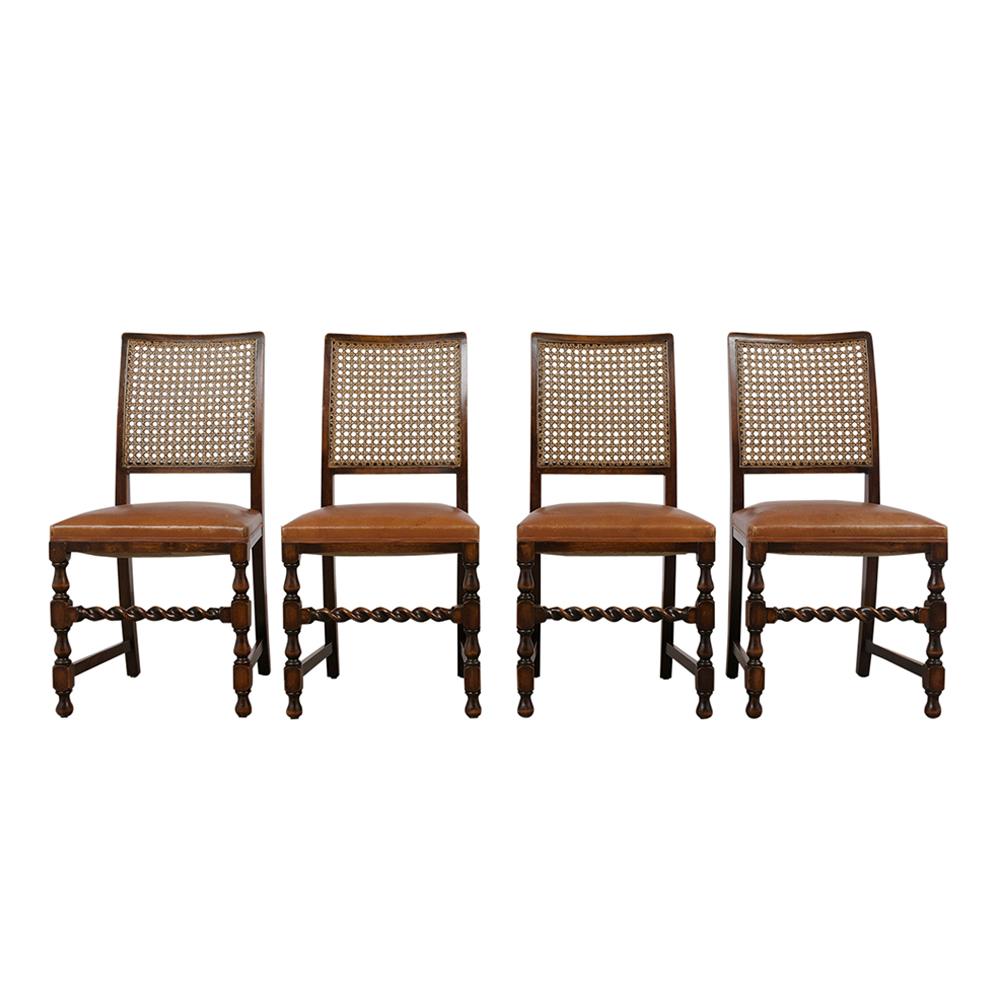 This set of eight French walnut wood Jacobean style dining chairs features a twisted carved stretched legs and original walnut finish in great condition. The chairs have a newly caned back and are upholstered in the original tan colored leather seat