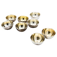 Set of eight washbasins in smooth silver with double friezes on the edges