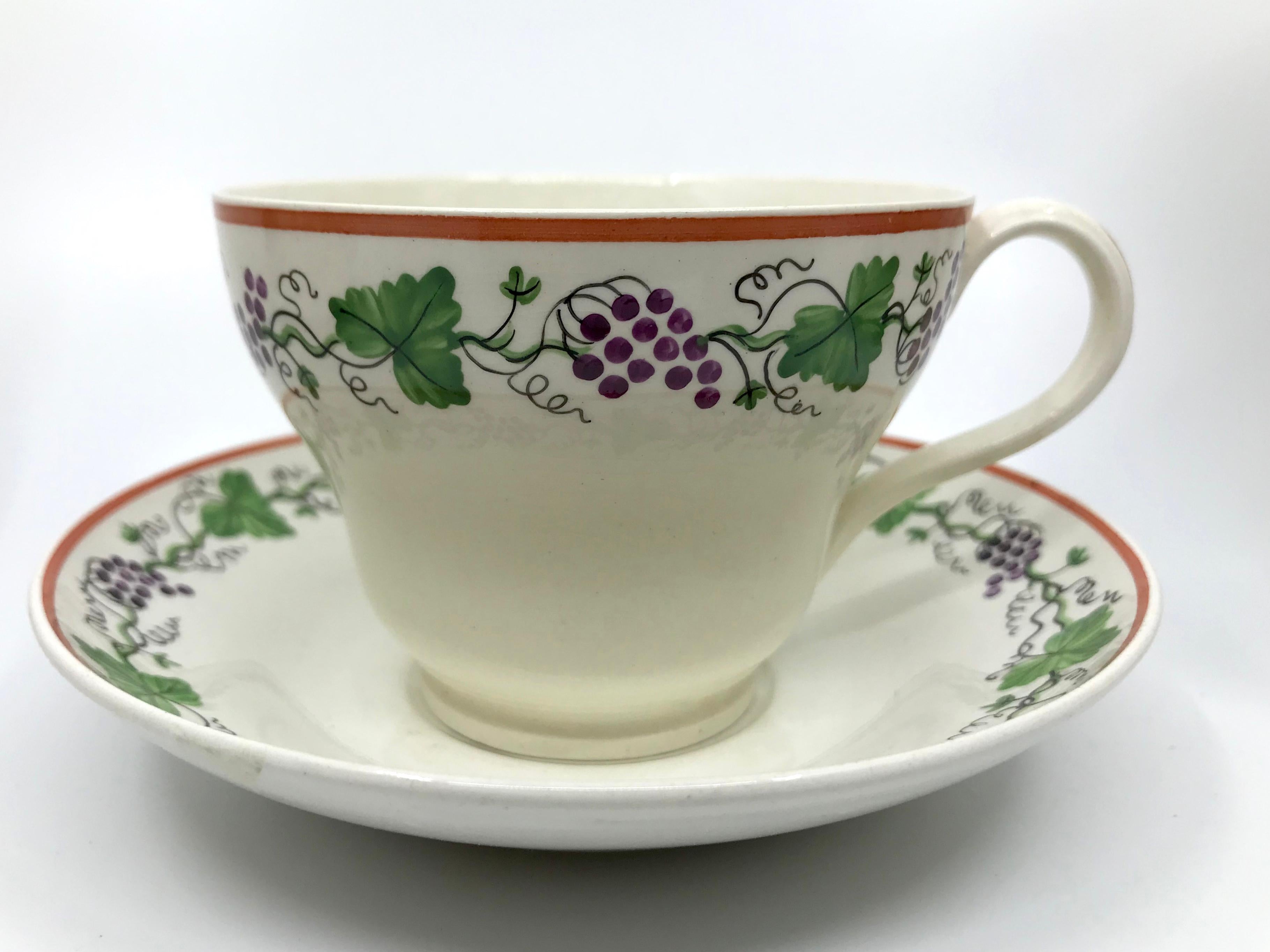 Set of eight Wedgwood creamware grape leaf cups and saucers. Antique creamware cups and saucers with scrolling hand-painted grape vines with green grape leaves, purple grape clusters and red brick rims. England, early 19th century. 
Dimensions: Cup