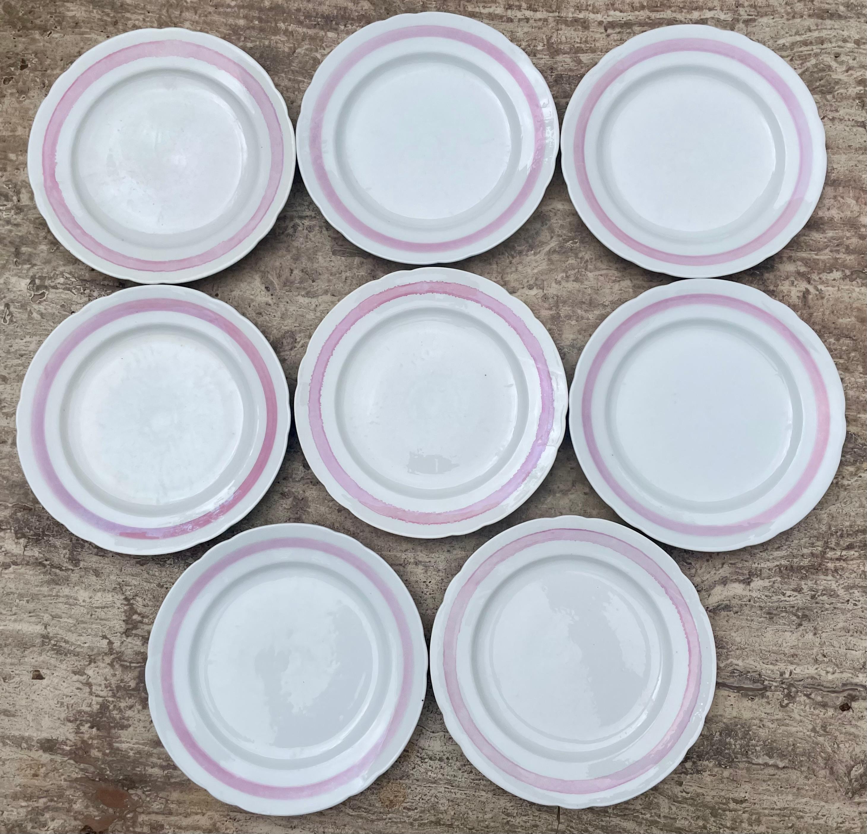 Set of eight white and pink banded plates. Scalloped white plates with pink banding with markings C. Tielsch & Co. Germany, 1880's

Dimensions: 9