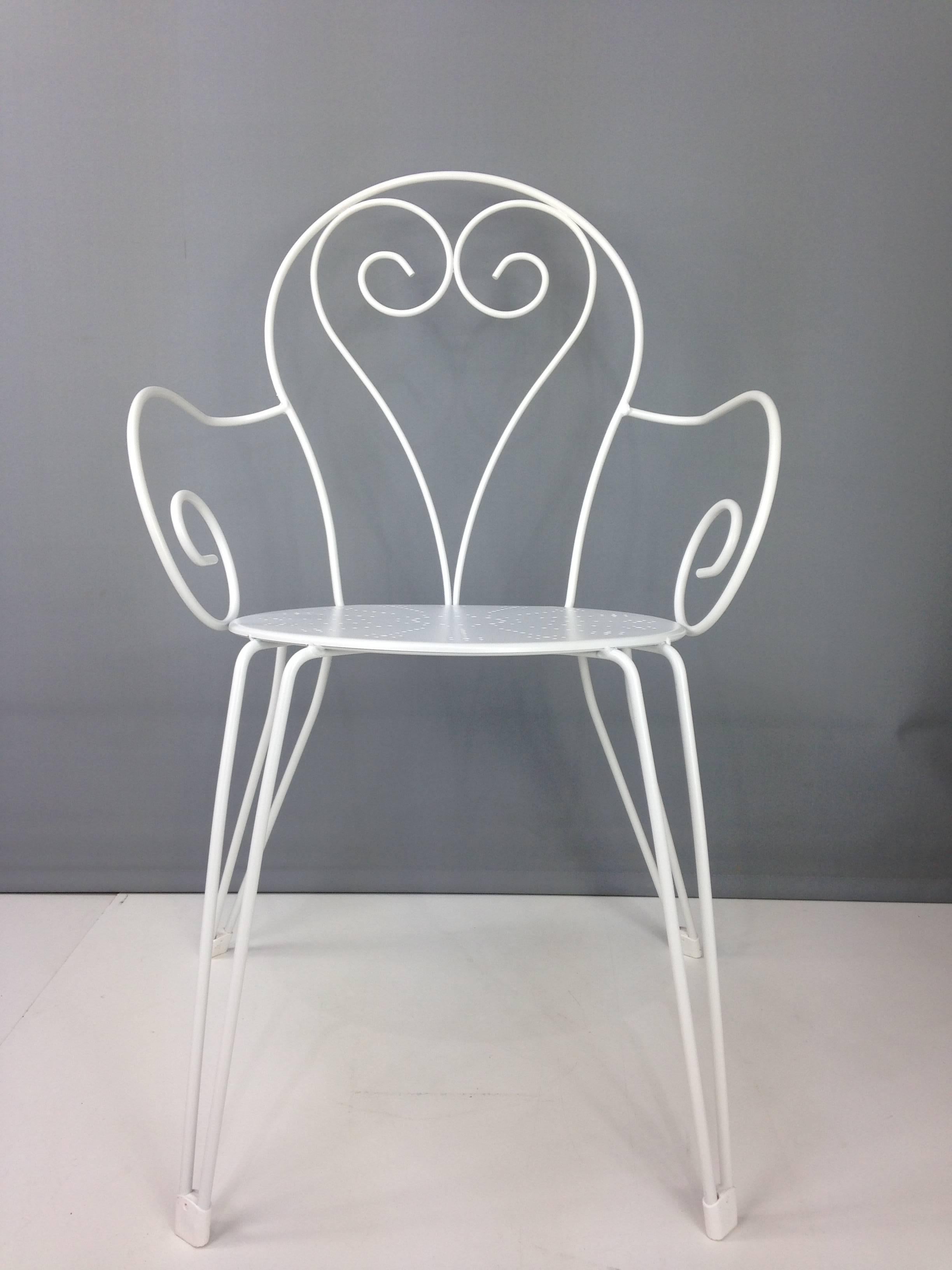 Voluptuousness, romance and poetry for these wrought iron set of eight outdoor white lacquered armchairs with perforated seats. On your terrace, in your veranda, in the middle of your garden and even around the pool, a love story made in Italy.