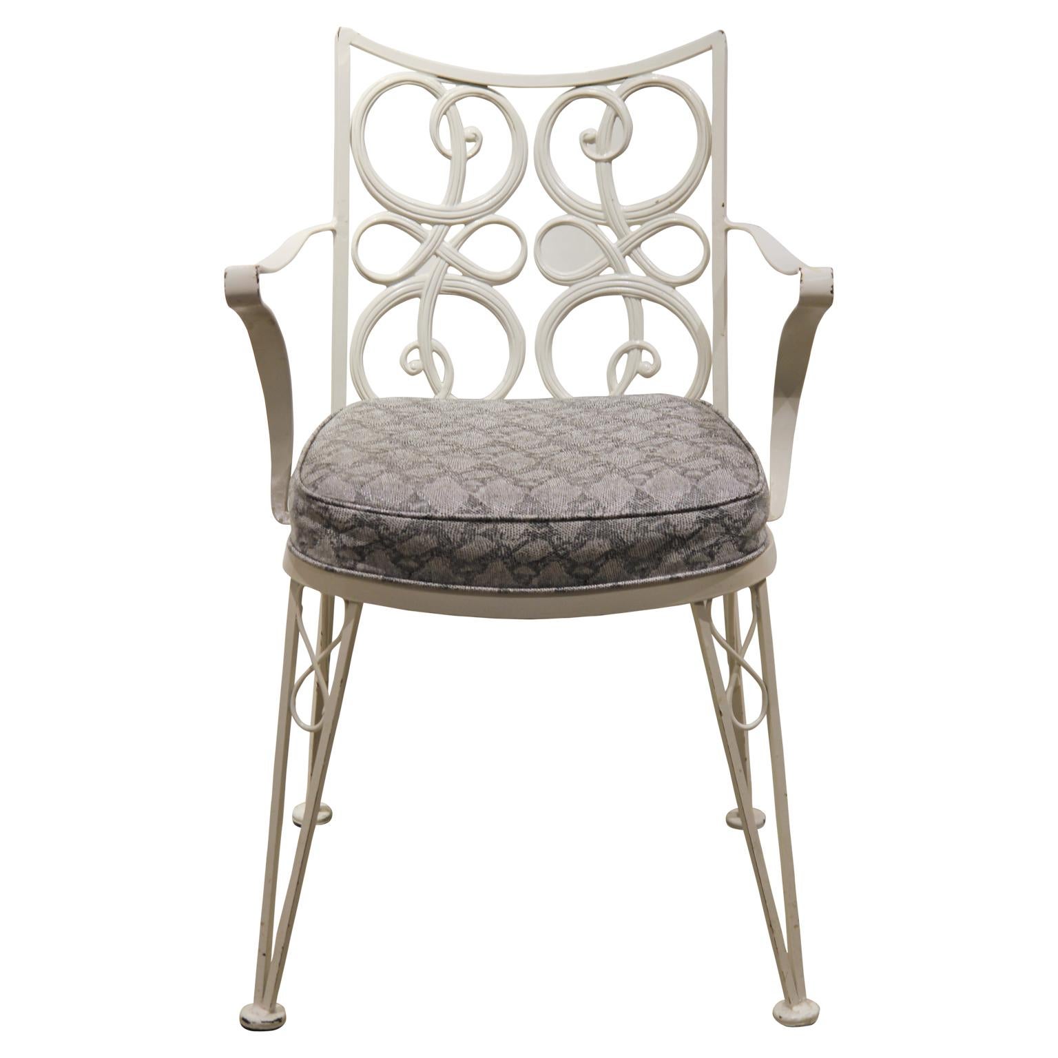 Set of eight Russell Woodard style chairs with a scale patterned seat cover. The chairs are made from aluminum so they will not rust. They are painted white with a nice grey seat. Two chairs have arm rest and the rest do not.