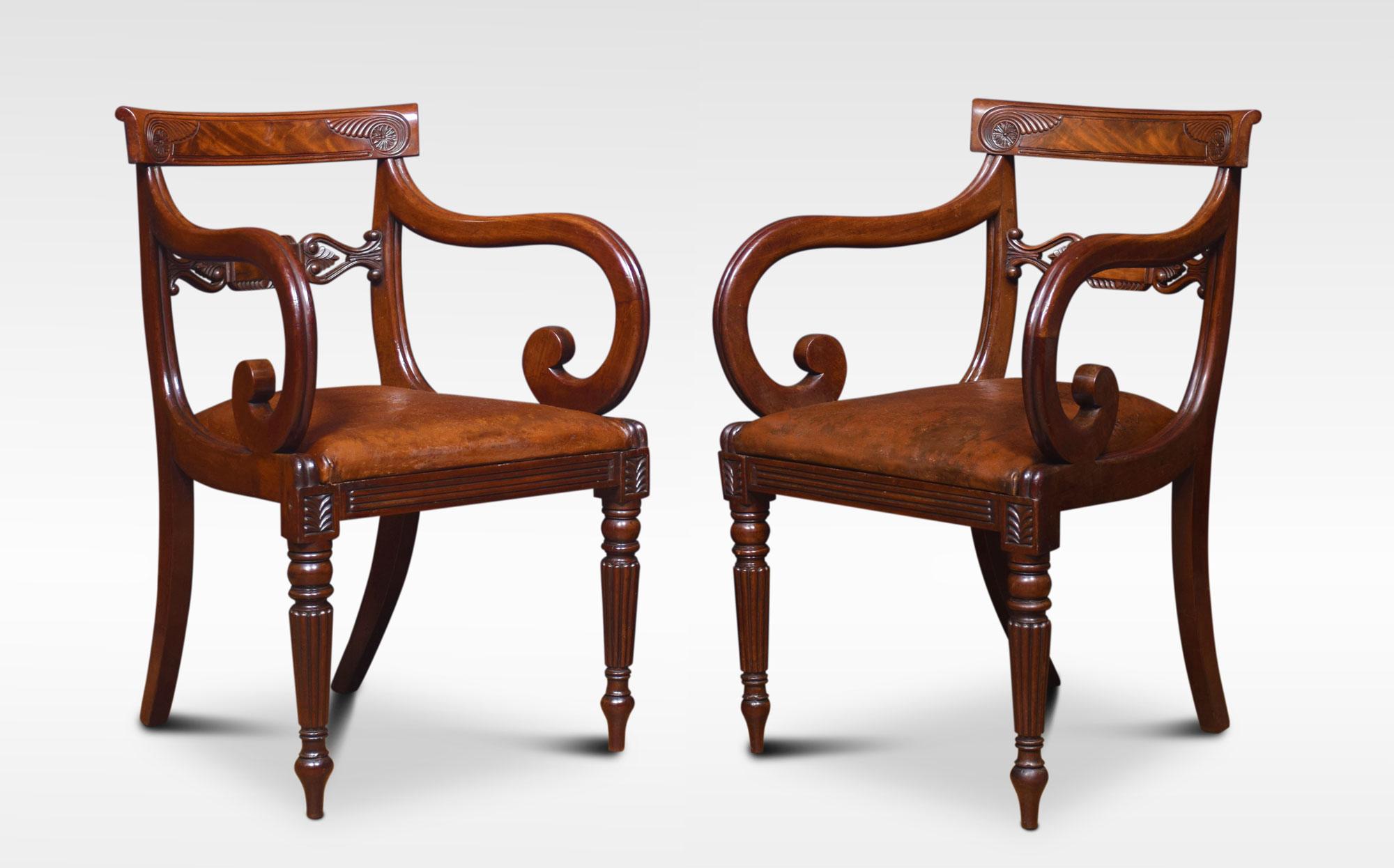 A set of eight William IV mahogany dining chairs, in the manner of Gillows. Comprising of two carvers and six chairs. Each with anthemion carved top rail and shaped backrest, to the brown leather drop-in seats. All raised up on tapering fluted front