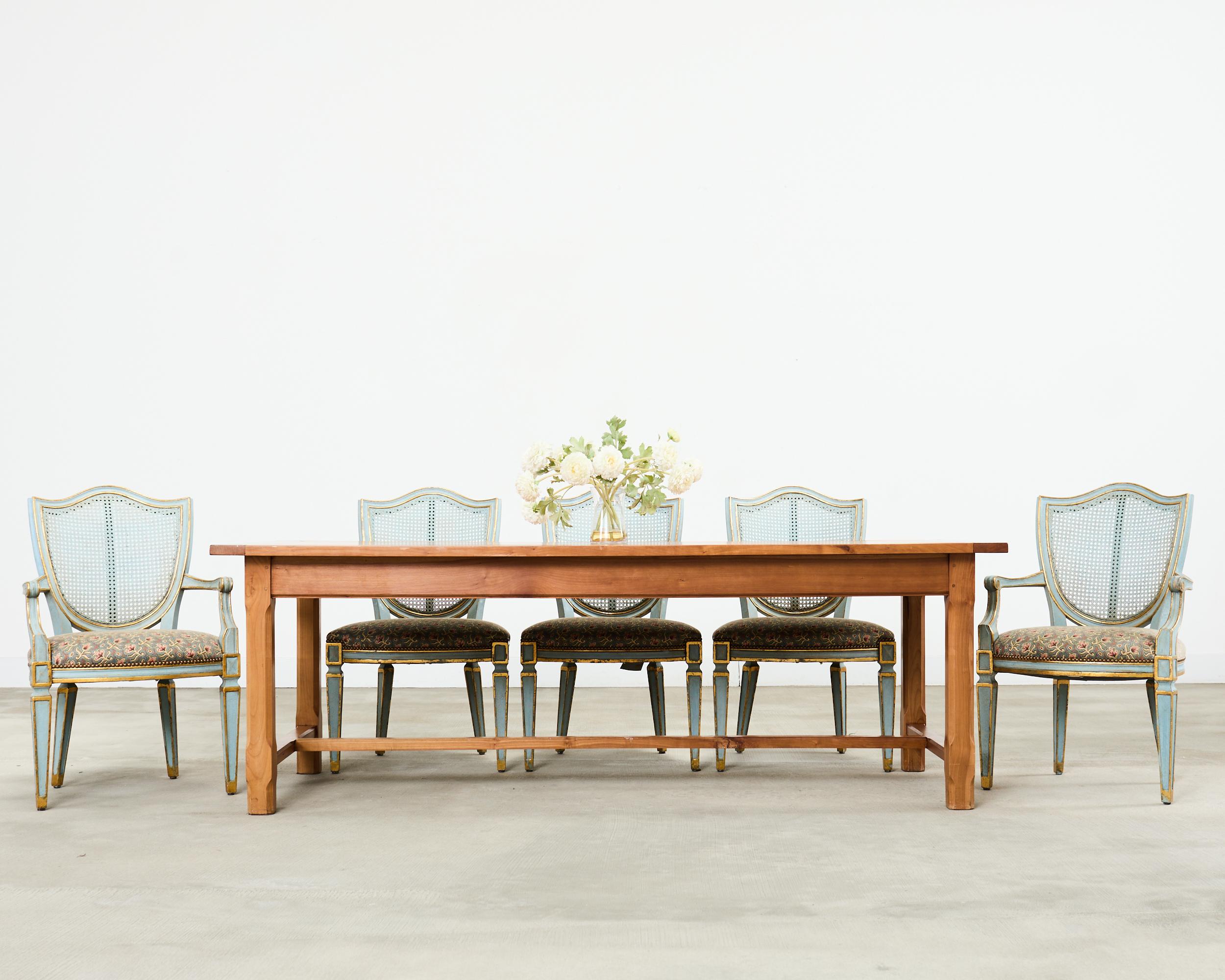Fantastic set of eight bespoke painted dining chairs made in the grand Louis XVI taste by William Switzer in Canada. Model number WS1A-0801AR shield back dining chairs feature a distinctive back inset with woven cane. The hand-made frames feature a