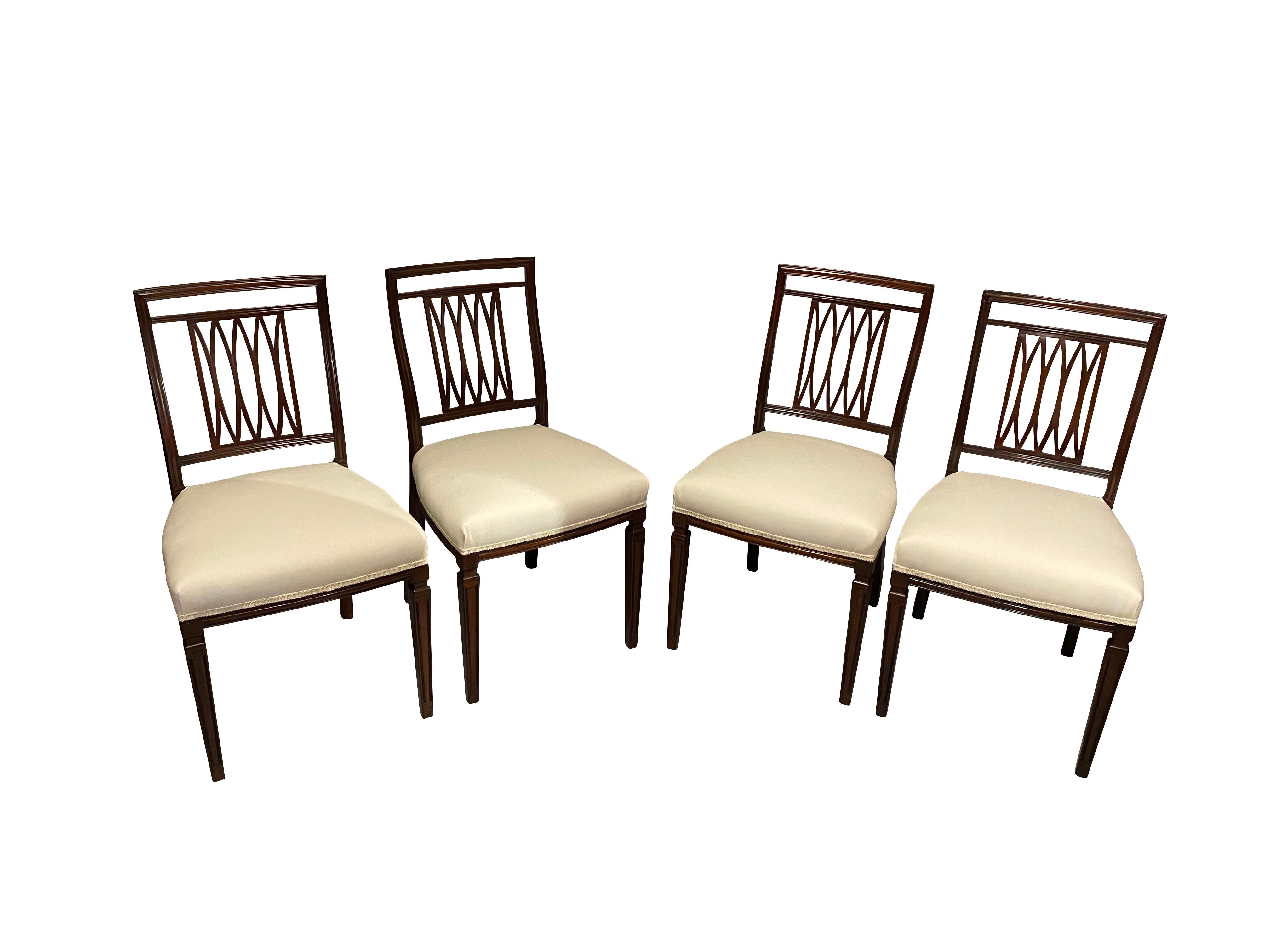 Consisting of a pair of armchairs and sixteen side chairs, each with a rectangular back with trellis splats, upholstered seats raised on square tapered fluted legs. Resided on Park Avenue in New York for the first half of the 20th century and were
