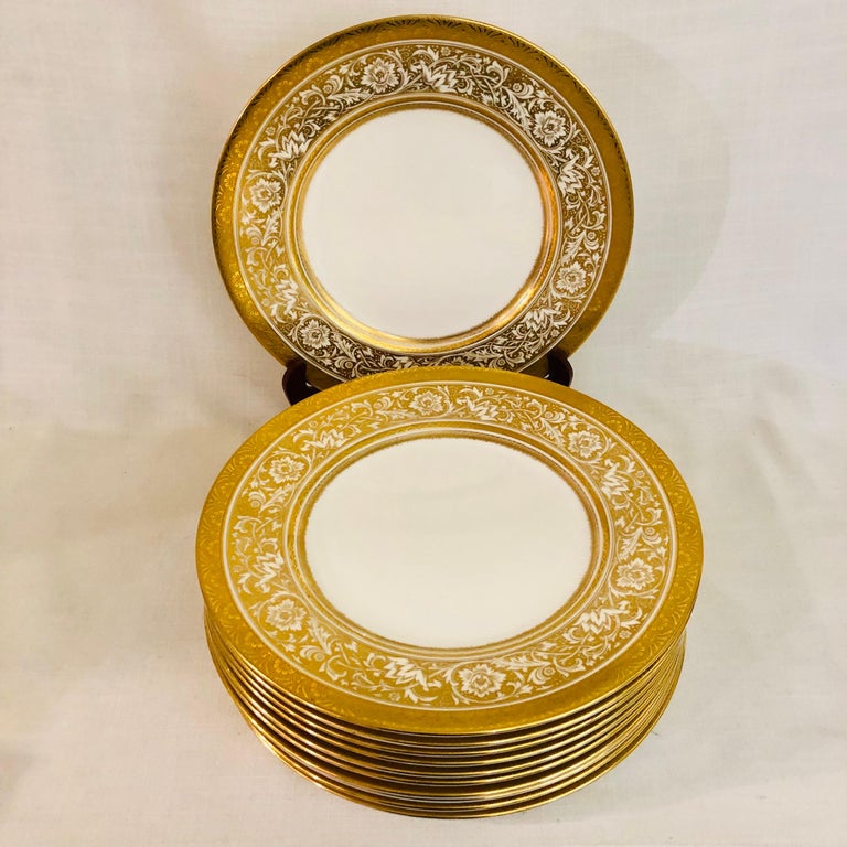 This is an exquisite set of eleven Minton Porcelain Ball dinner plates. They have a beautiful gold and white arabesque decoration of flowers with an embossed gilded border. These Minton porcelain ball dinner plates were made exclusively for the