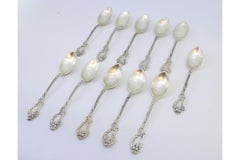 Set of eleven silver teaspoons with reliefs and shell handles