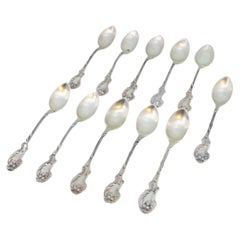 Set of eleven silver teaspoons with reliefs and shell handles