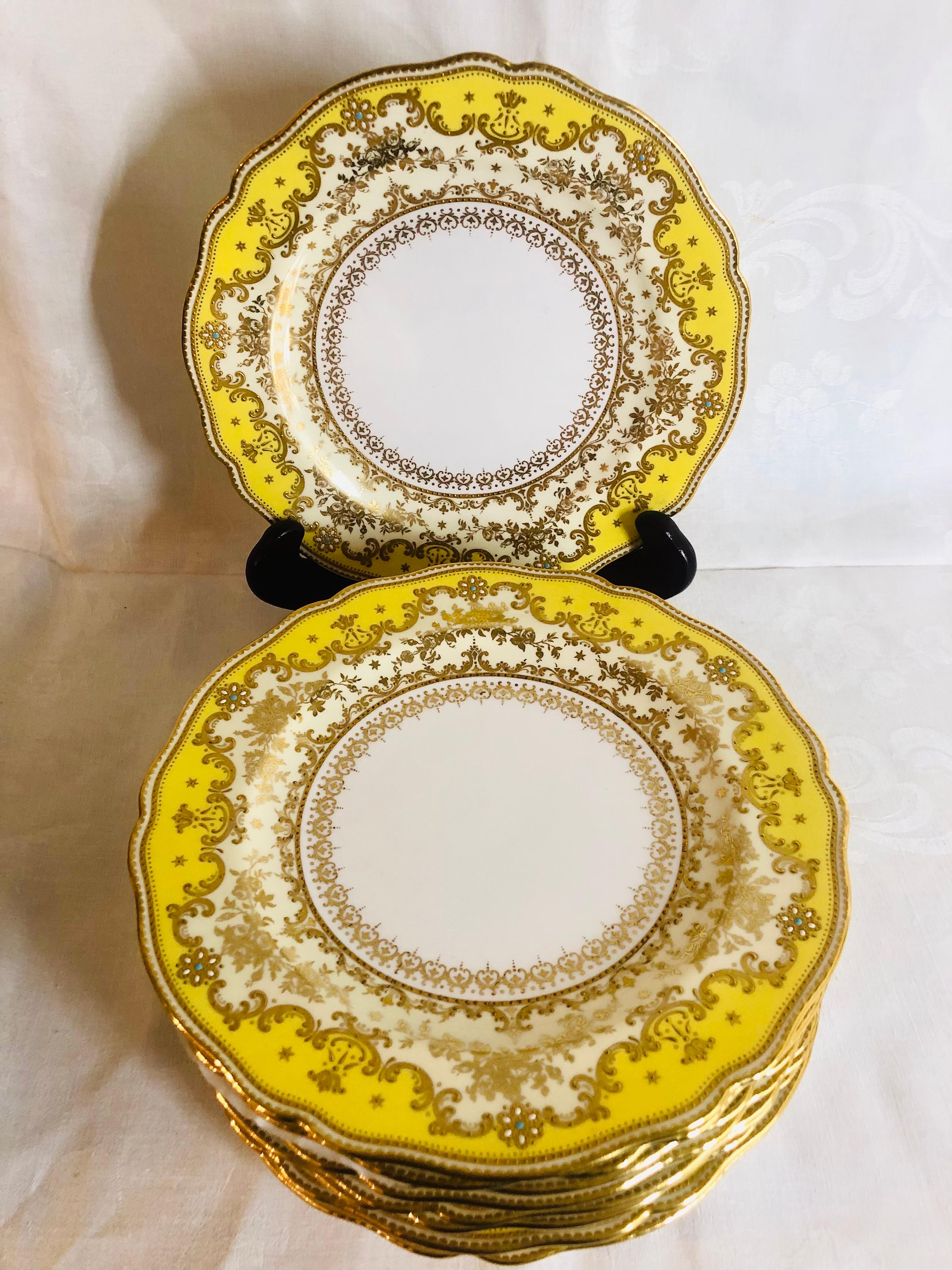 This is an absolutely stunning set of eleven yellow luncheon or dessert plates made of Copeland's jeweled porcelain. Each plate has a yellow fluted border with raised gold arabesque decoration. Inside this outer border, is a cream border with a gold