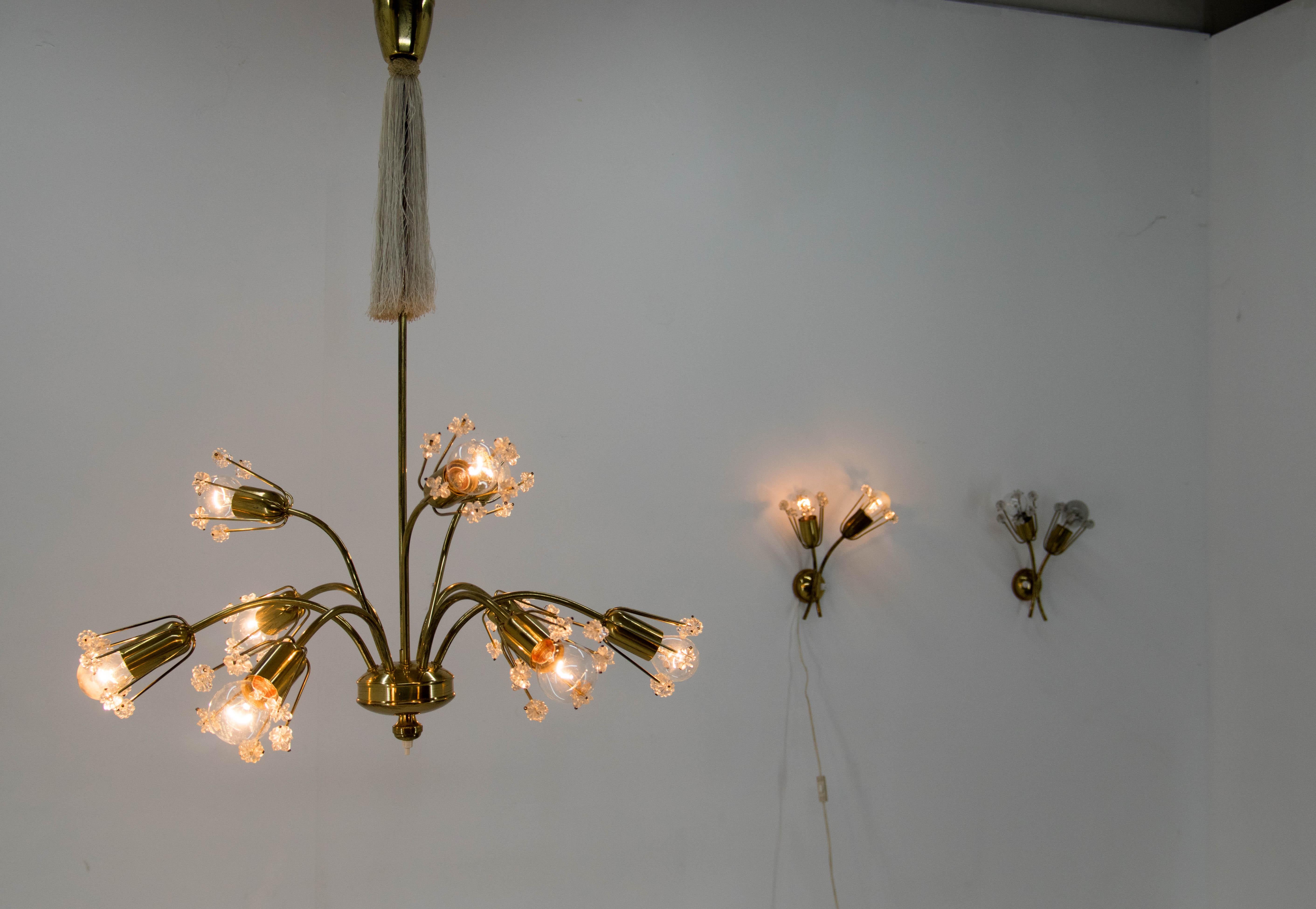 Designed in 1950s by Emil Stejnar and executed by Rupert Nikoll. Switch on the bottom part of 9-flamming chandelier could turn off upper three bulbs. Lacquered brass with minor age patina. No crystal parts missing. 
max 40W, E12-E14