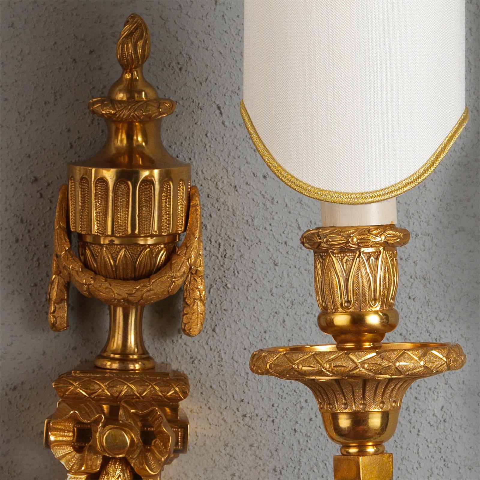 This precious Set of Empire Style Gilt Bronze Wall Sconces by Gherardo Degli Albizzi features many finely hand chiseled details. This model is typical of French Empire period due to its rich ornamentation with geometric motifs, acanthus leaf volutes