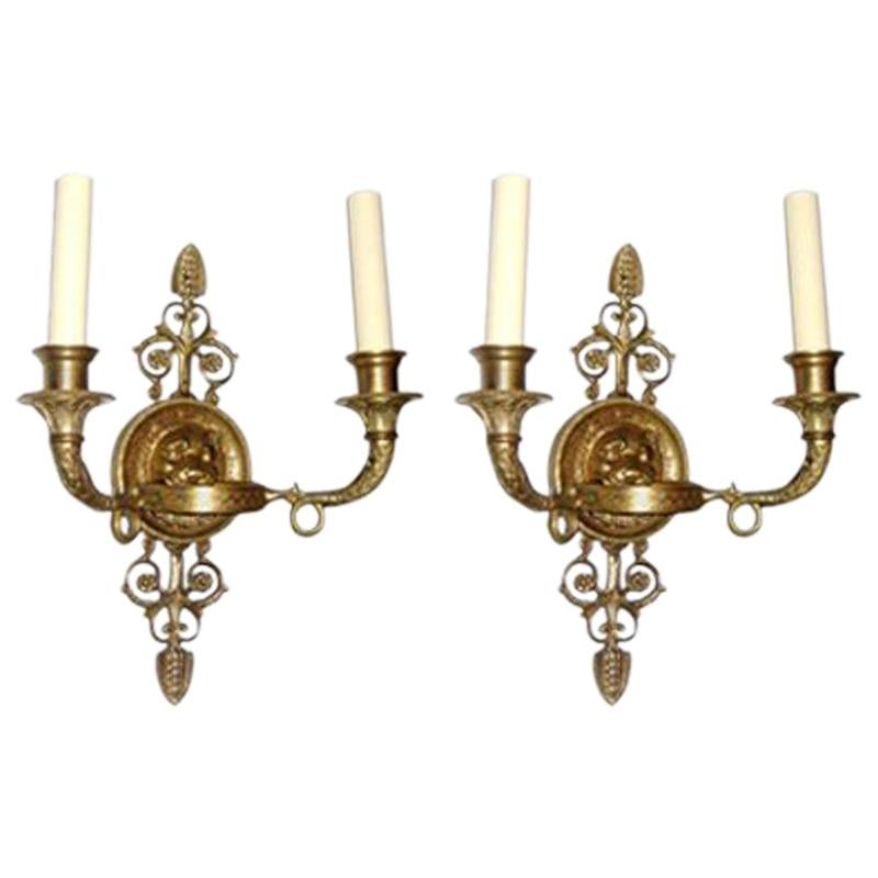 Set of eight French circa 1900 Empire style two-arm sconces with lion’s head motif on backplate and original gilt finish. Sold in pairs.

Measurements:
Height 12