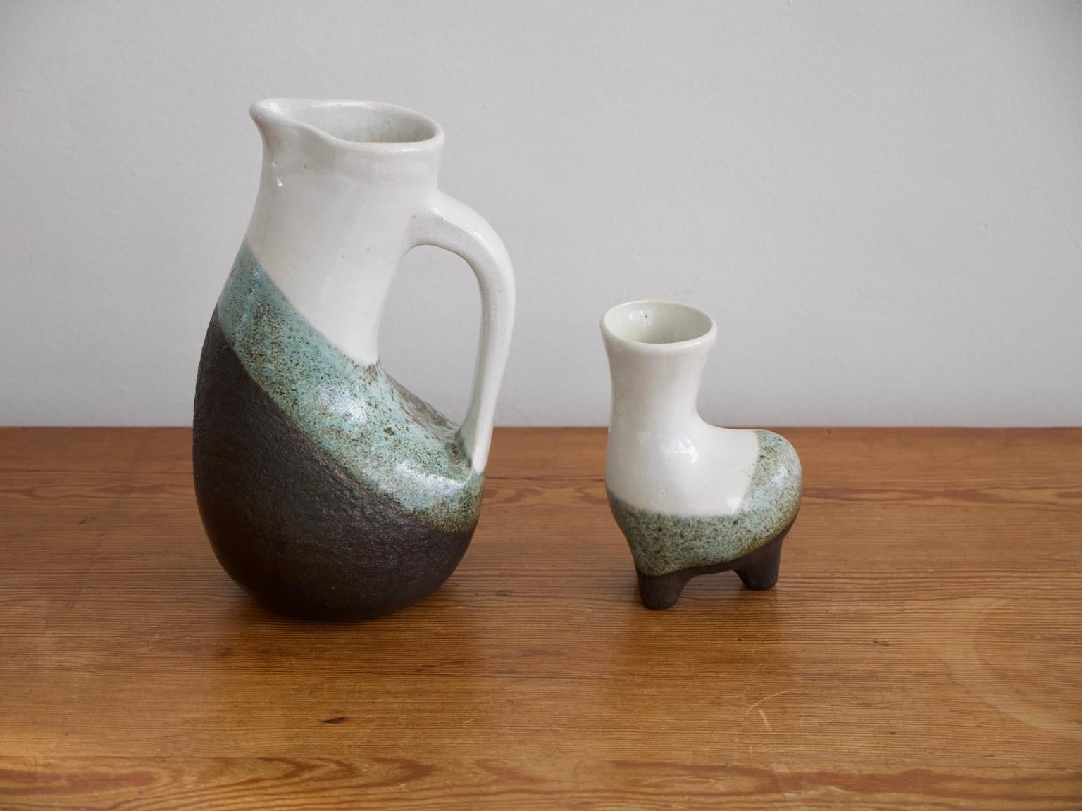 Large jug and a smaller vase of zoomorphic form made of enameled earthenware by a French ceramist, painter and sculptor Gilbert Valentin, (1928-2001).
Measures: Jug H 31.5 cm, W 17.5 cm, D 16.5 cm.
Vase H 17.3 cm, W 11.5 cm, D 8.5 cm.