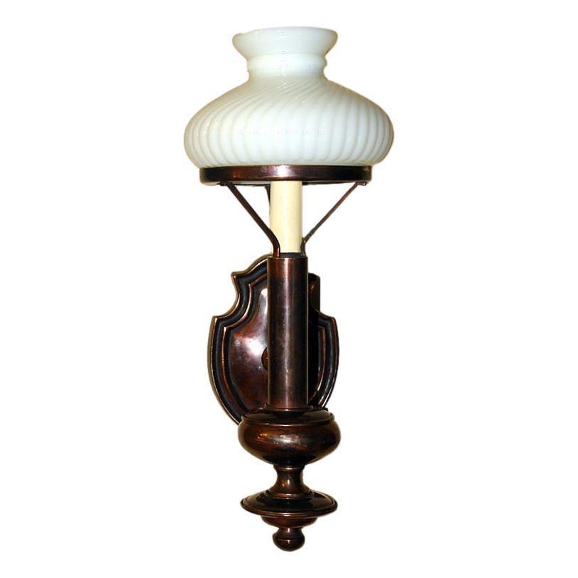 Set di 10 appliques neoclassiche inglesi degli anni '50 circa, in bronzo patinato e con paralumi in vetro opalino. Venduto al paio.

Misure:
Altezza: 15